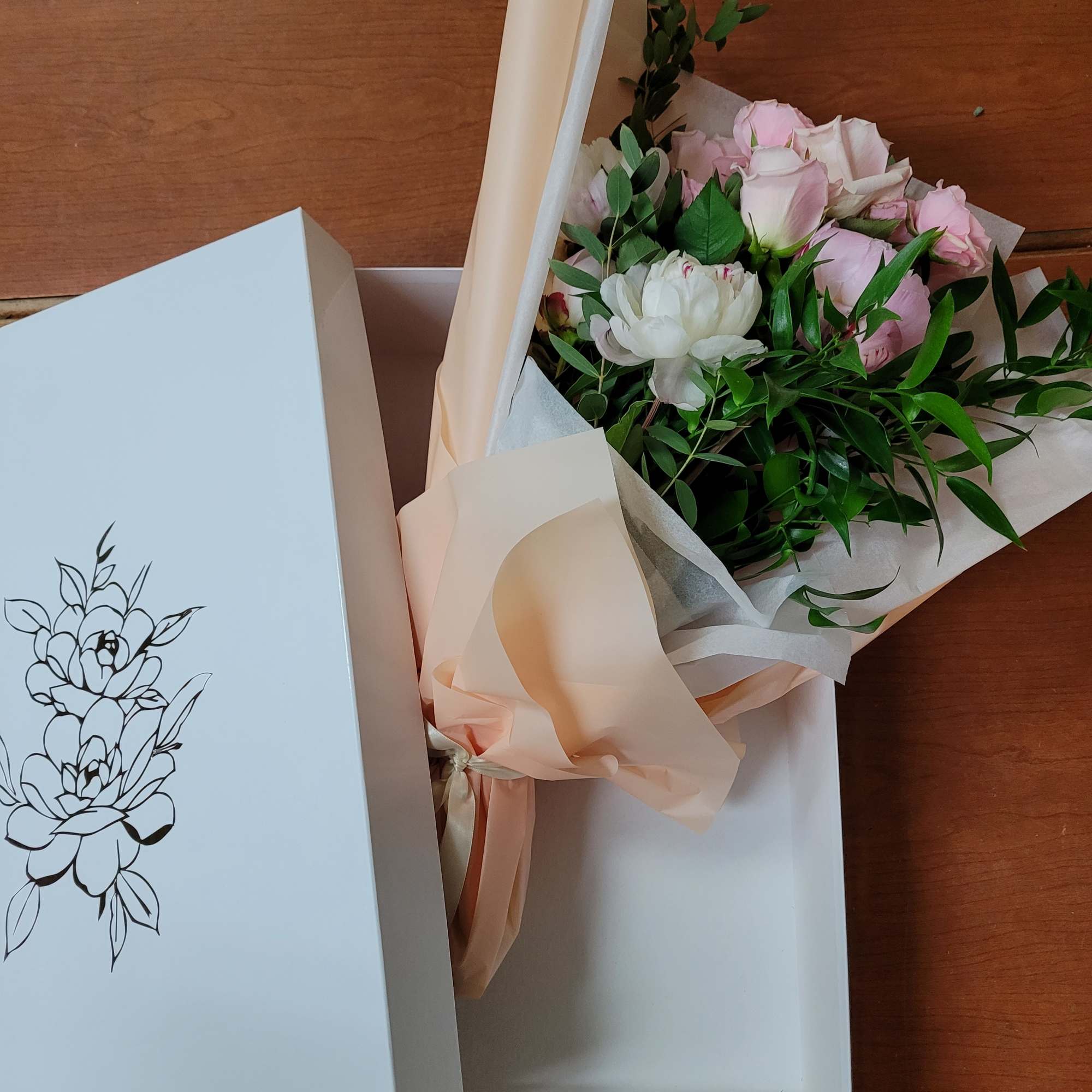 a collection of seasonally available blooms wrapped in our specialty wrapping and