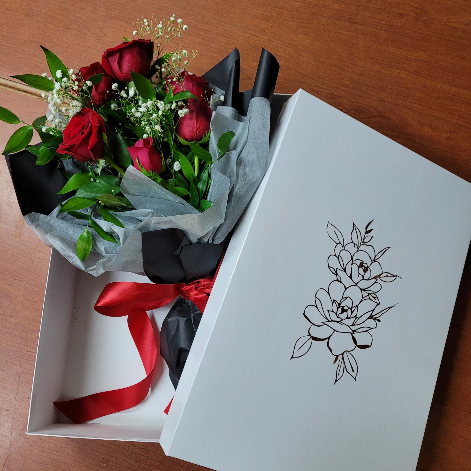 a collection of seasonally available blooms wrapped in our specialty wrapping and