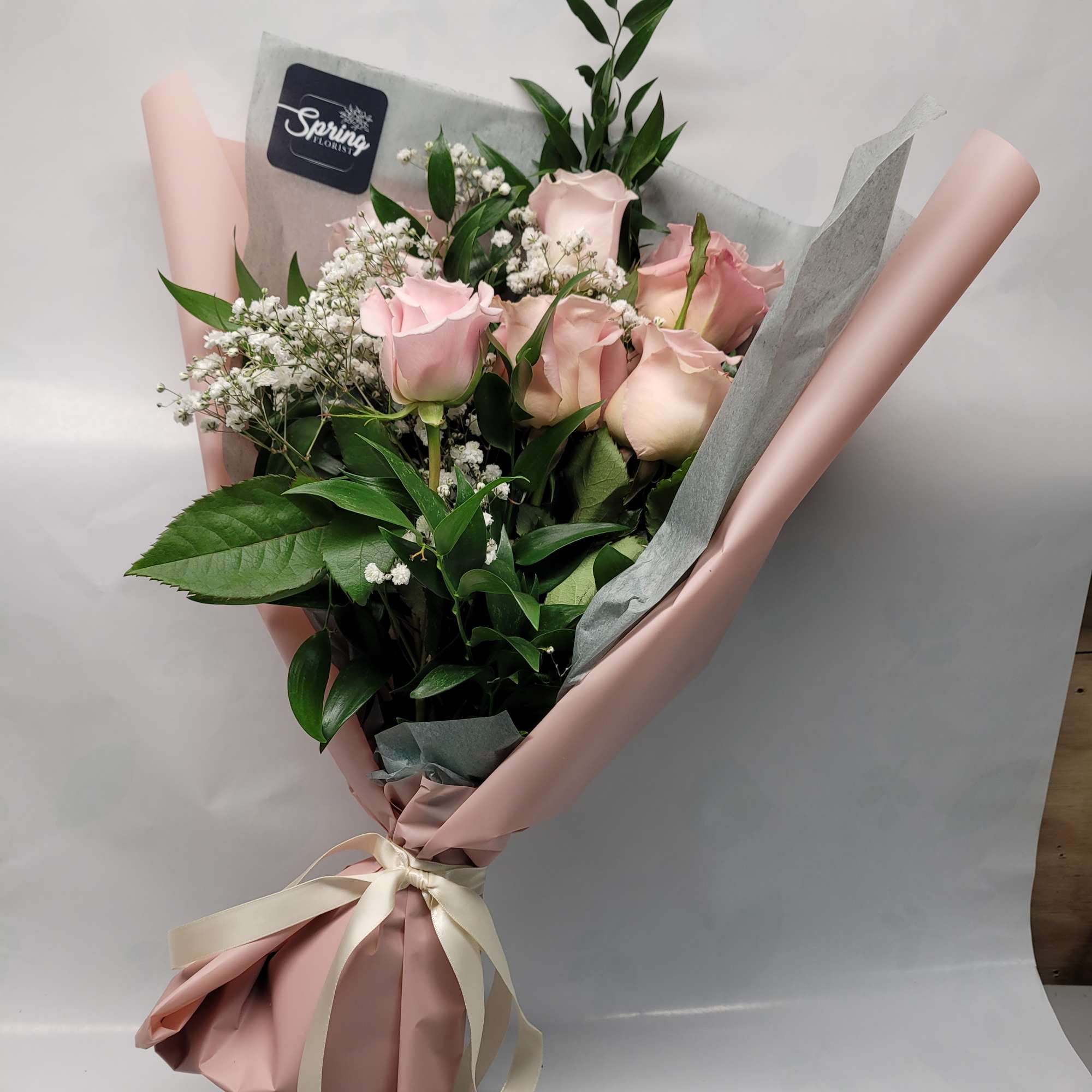 a collection of seasonally available blooms wrapped in our specialty wrapping and