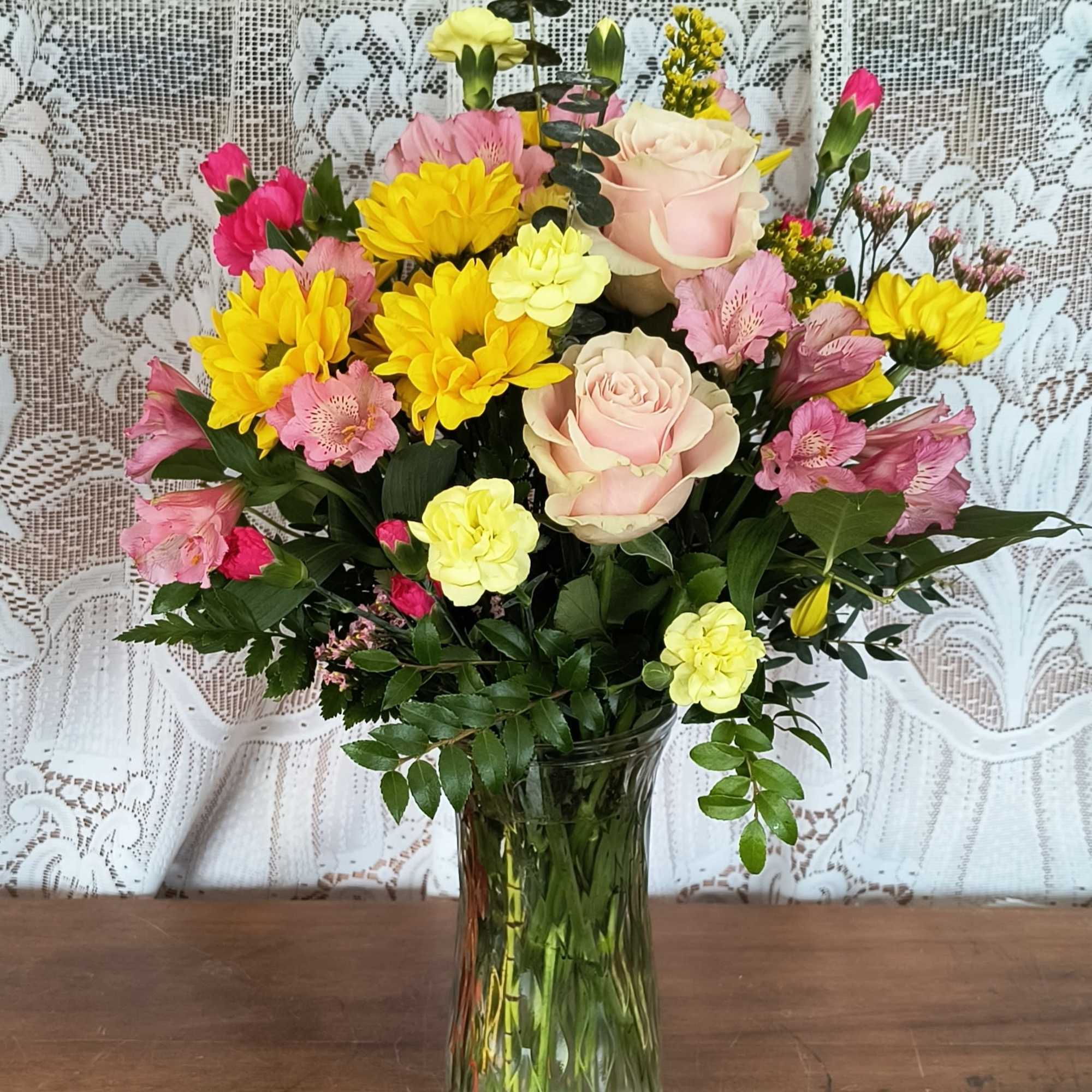 A cute as a button mix of pink and yellow flowers of