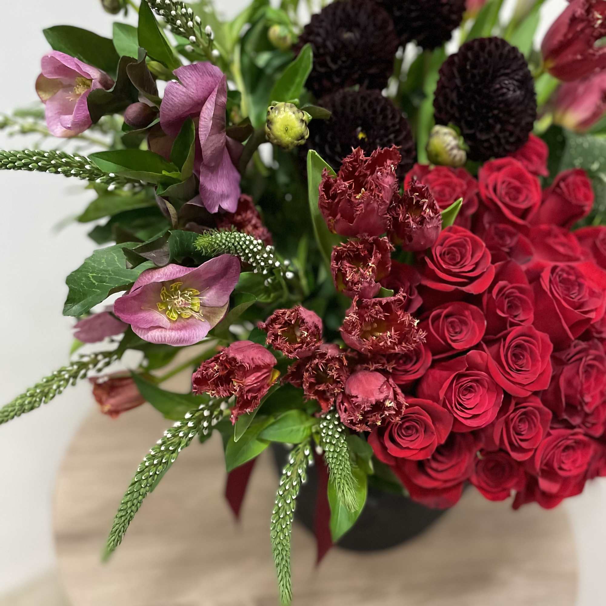 This stunning floral arrangement features a luxurious mix of red roses, green This stunning floral arrangement features a luxurious mix of red roses, green