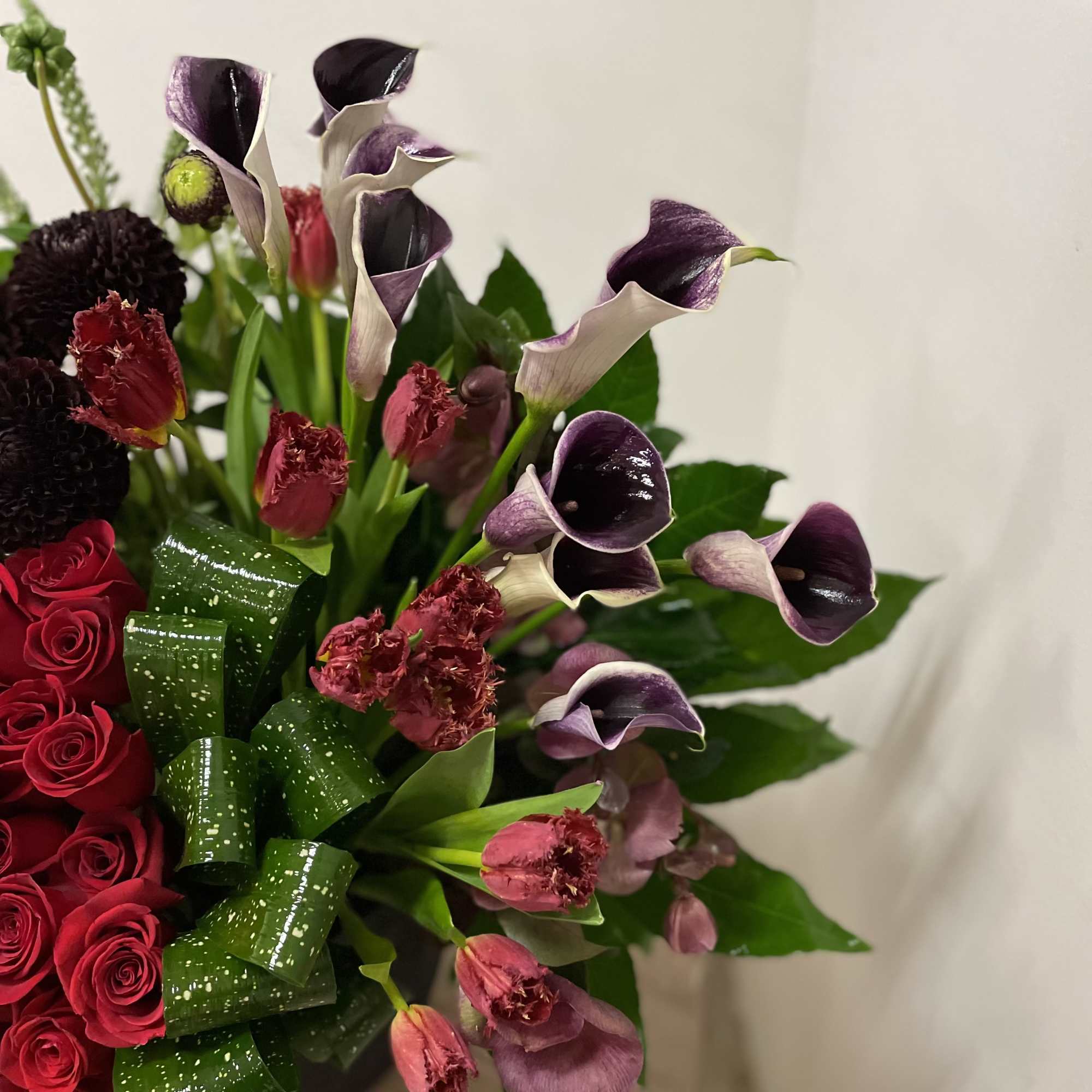 This stunning floral arrangement features a luxurious mix of red roses, green This stunning floral arrangement features a luxurious mix of red roses, green