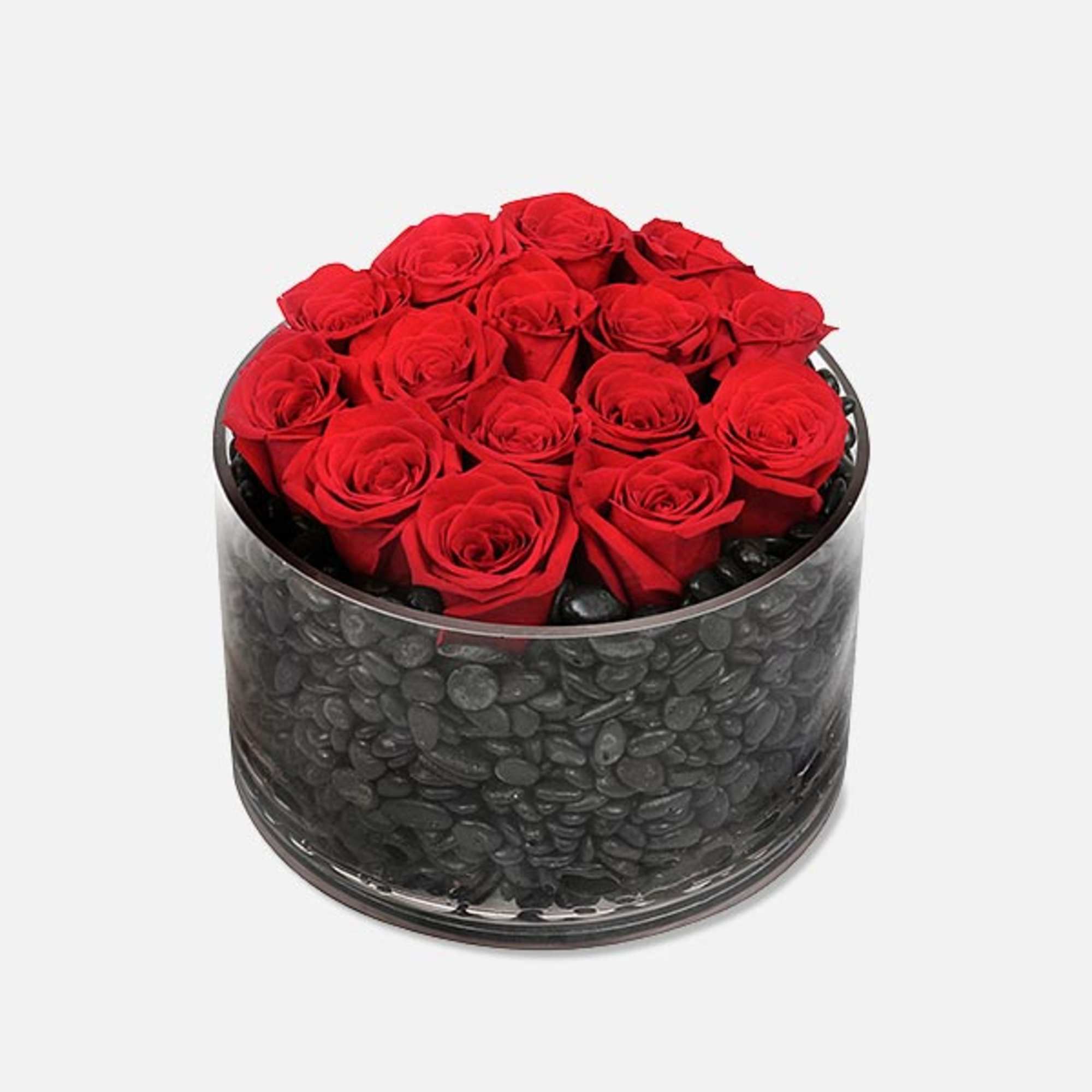 Filled with an array of dark polished stones, the circular dish contains Filled with an array of dark polished stones, the circular dish contains