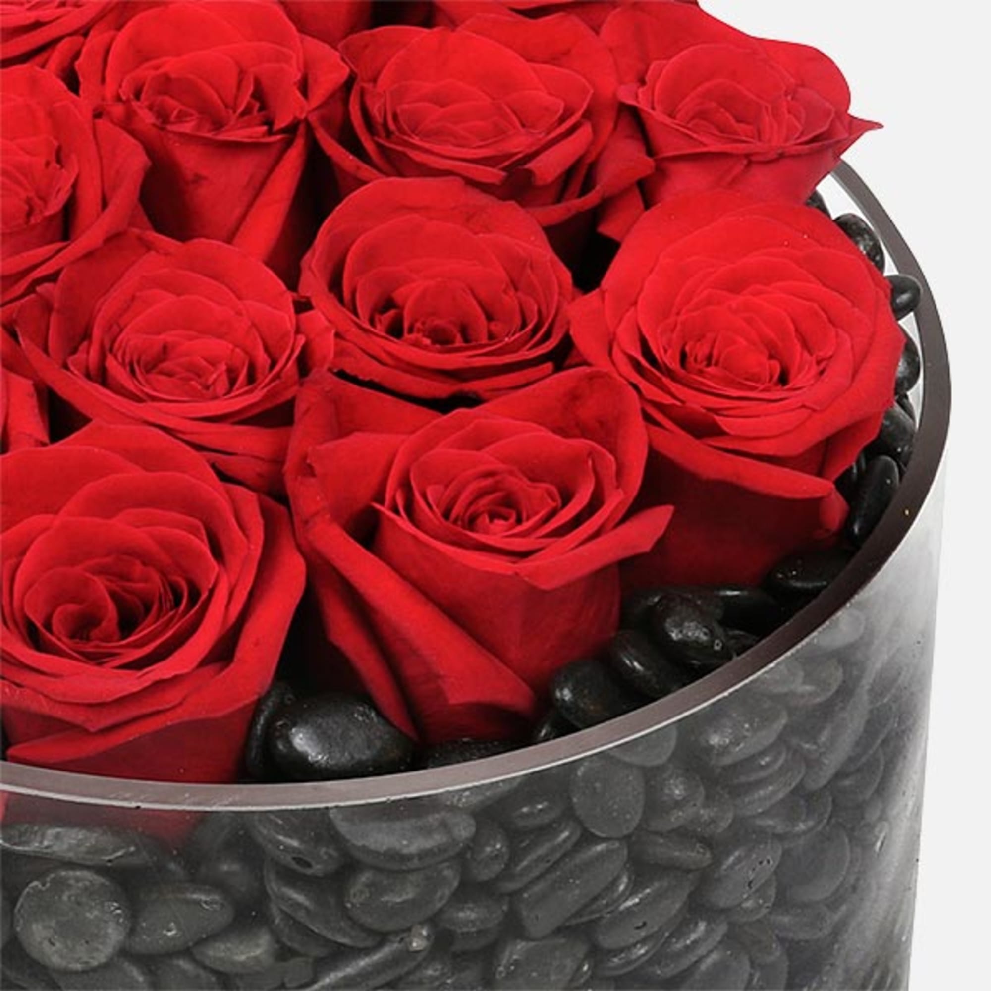 Filled with an array of dark polished stones, the circular dish contains Filled with an array of dark polished stones, the circular dish contains