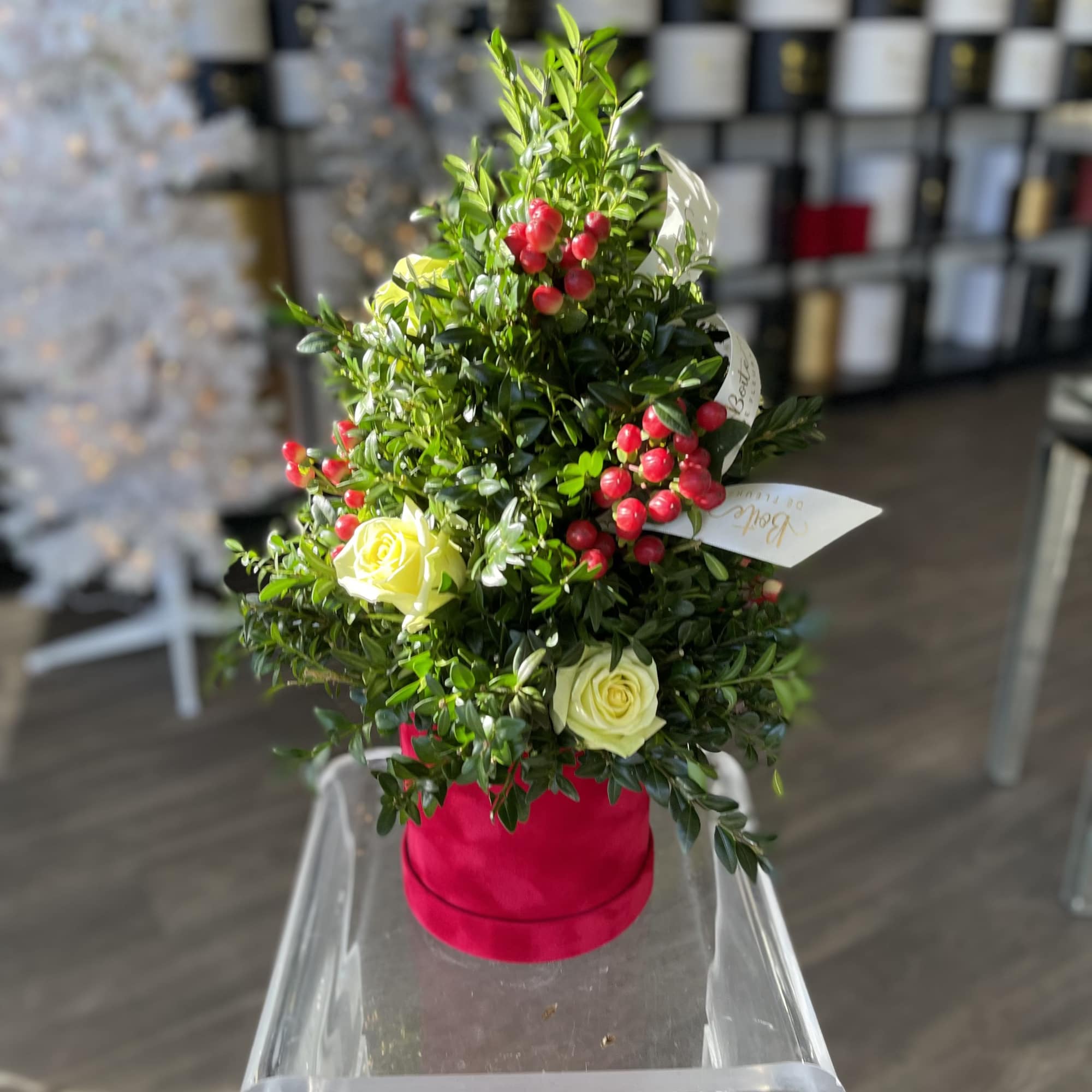 Myrtle leaves shaped in a Christmas tree with roses and hypericum are Myrtle leaves shaped in a Christmas tree with roses and hypericum are