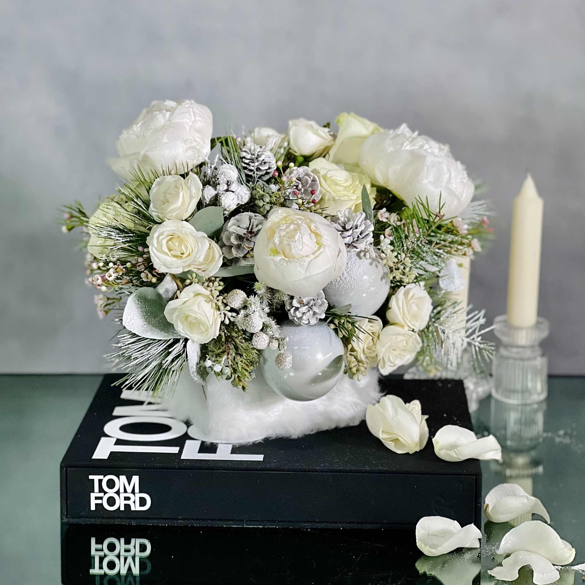 This arrangement will bring a sophisticated look with Peonies, Princess Holiday Greens