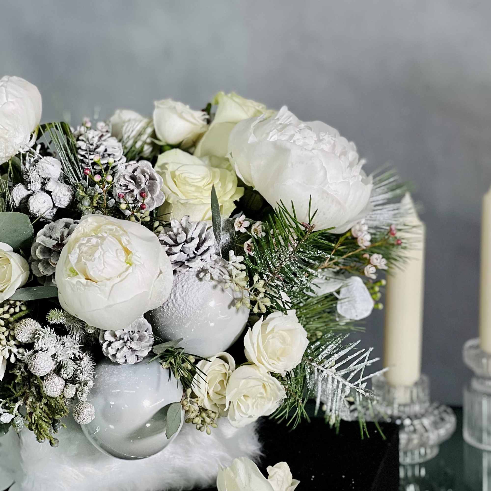 This arrangement will bring a sophisticated look with Peonies, Princess Holiday Greens