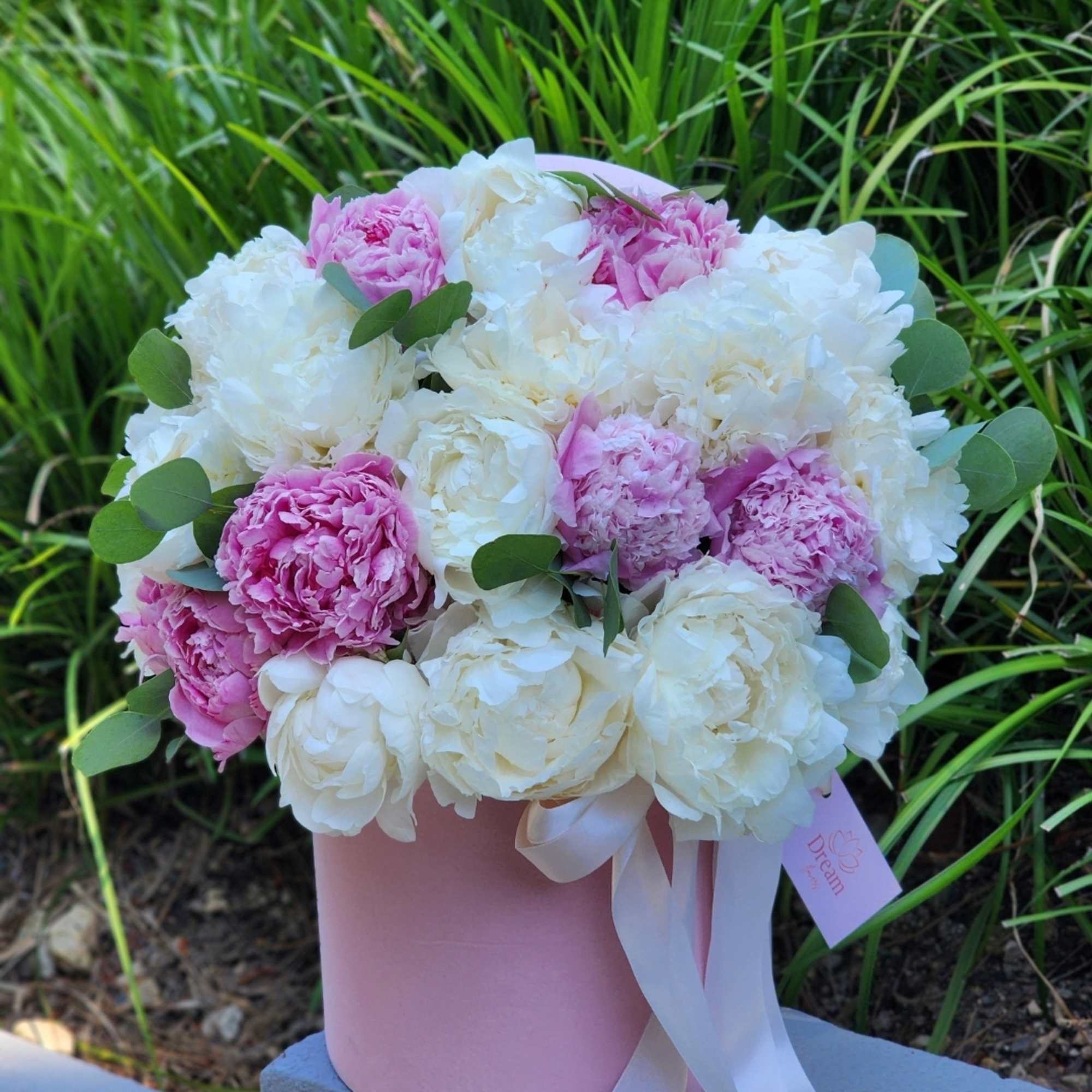 Indulge in the charm of our pink and white peonies, nestled within