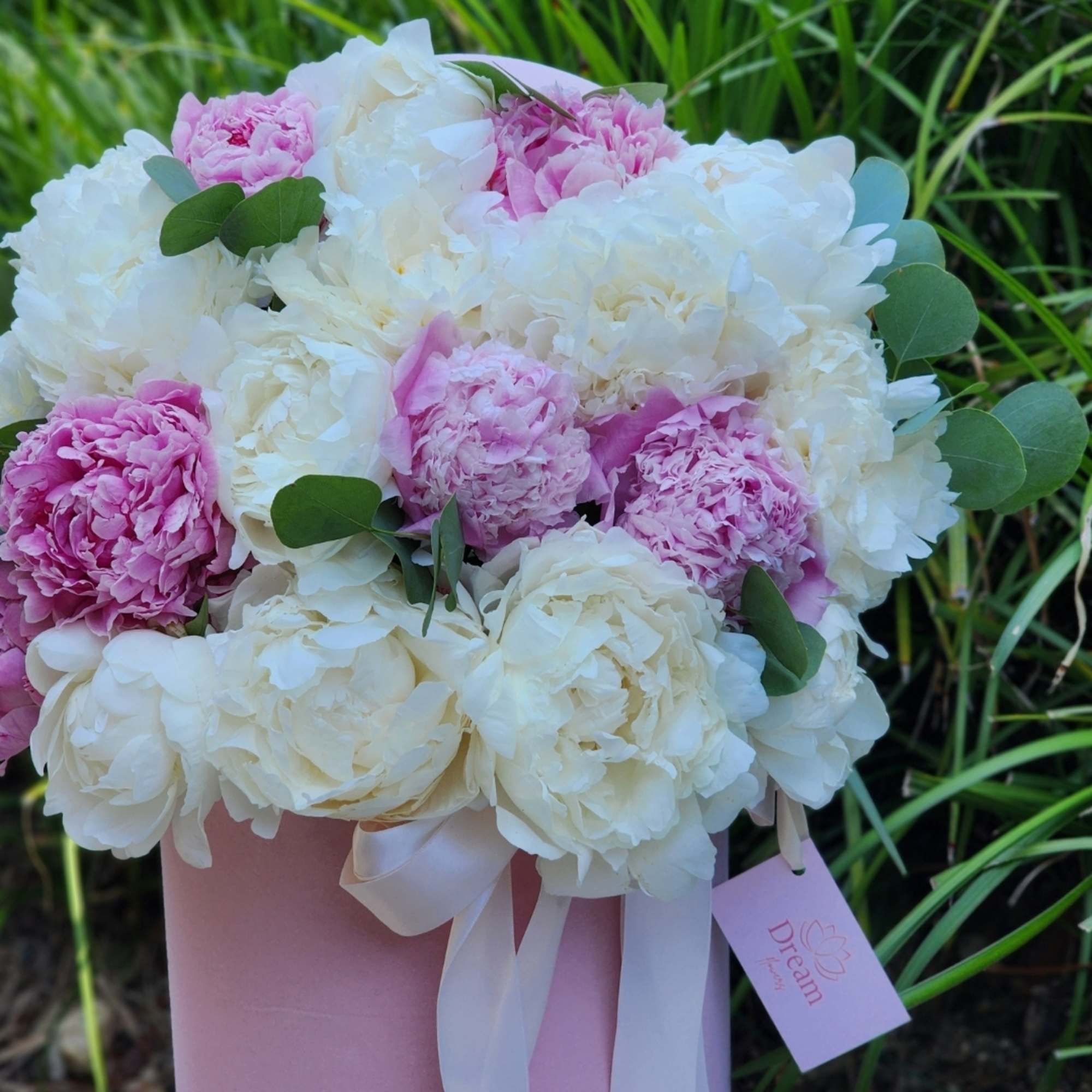 Indulge in the charm of our pink and white peonies, nestled within