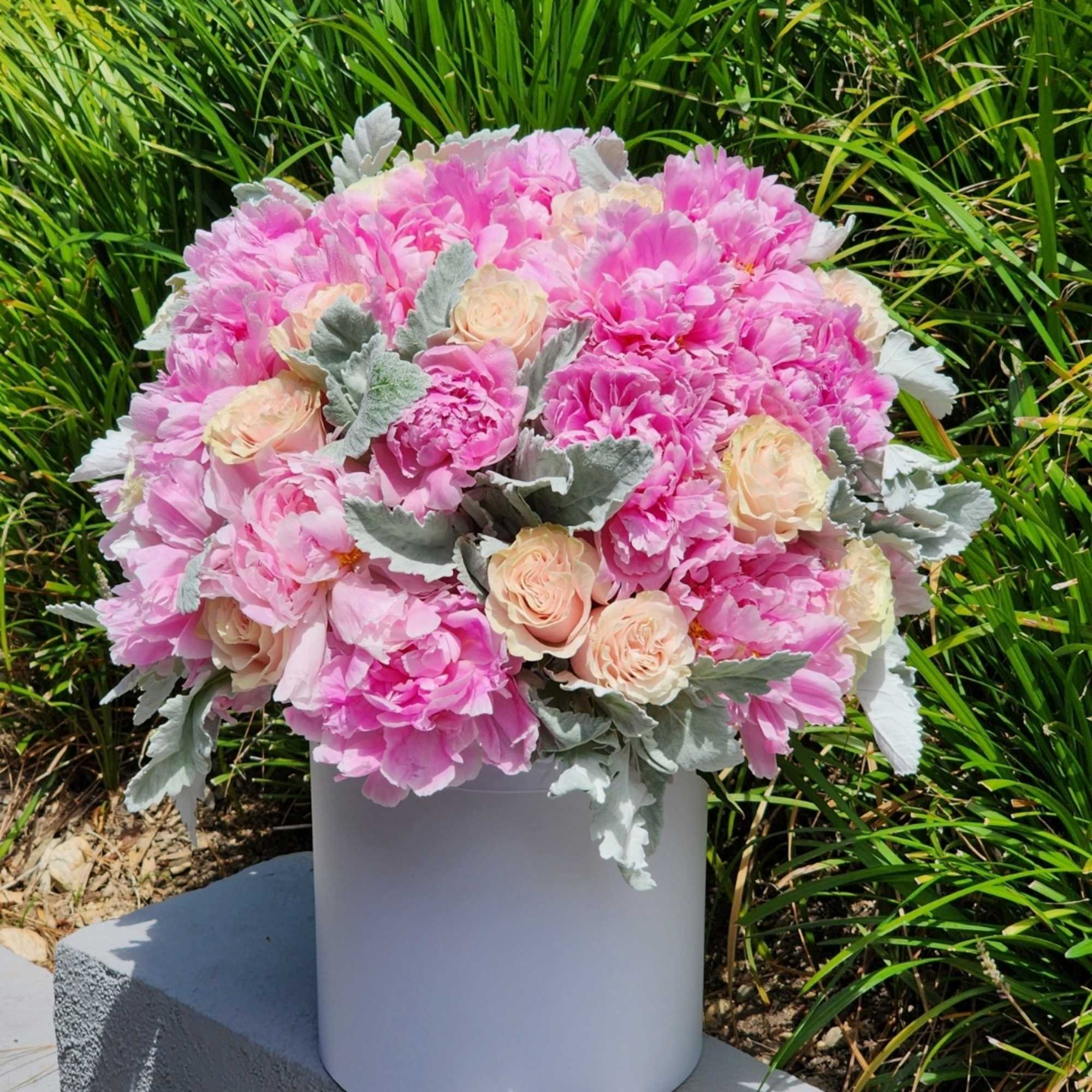 Indulge in the charm of our pink peonies, nestled within exquisite hatboxes
