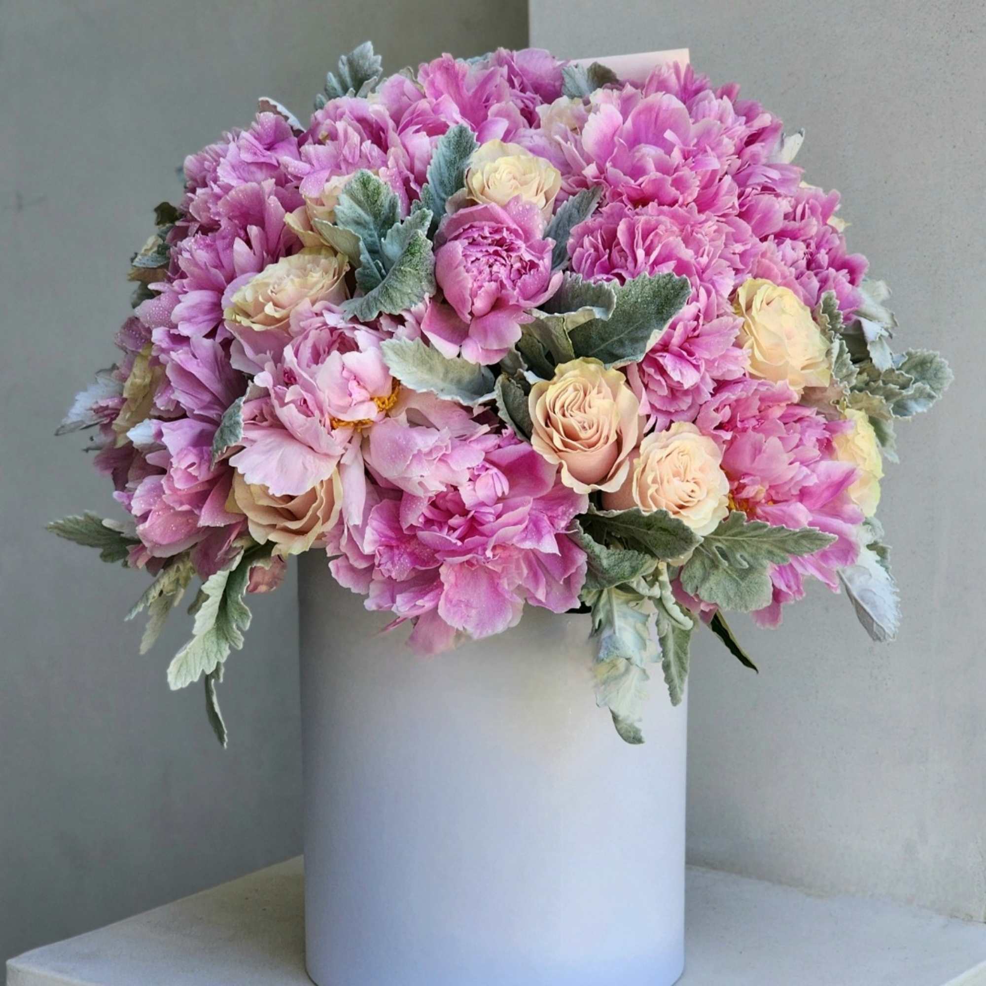 Indulge in the charm of our pink peonies, nestled within exquisite hatboxes