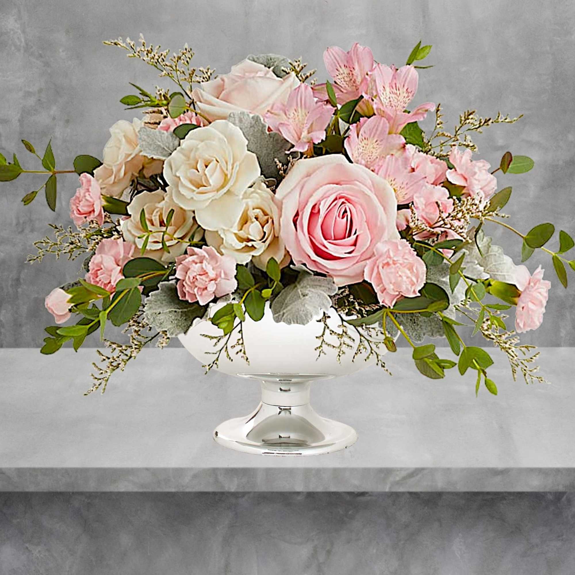 Illuminate love with embracing soft pastel shimmer and cradling an exquisite arrangement
