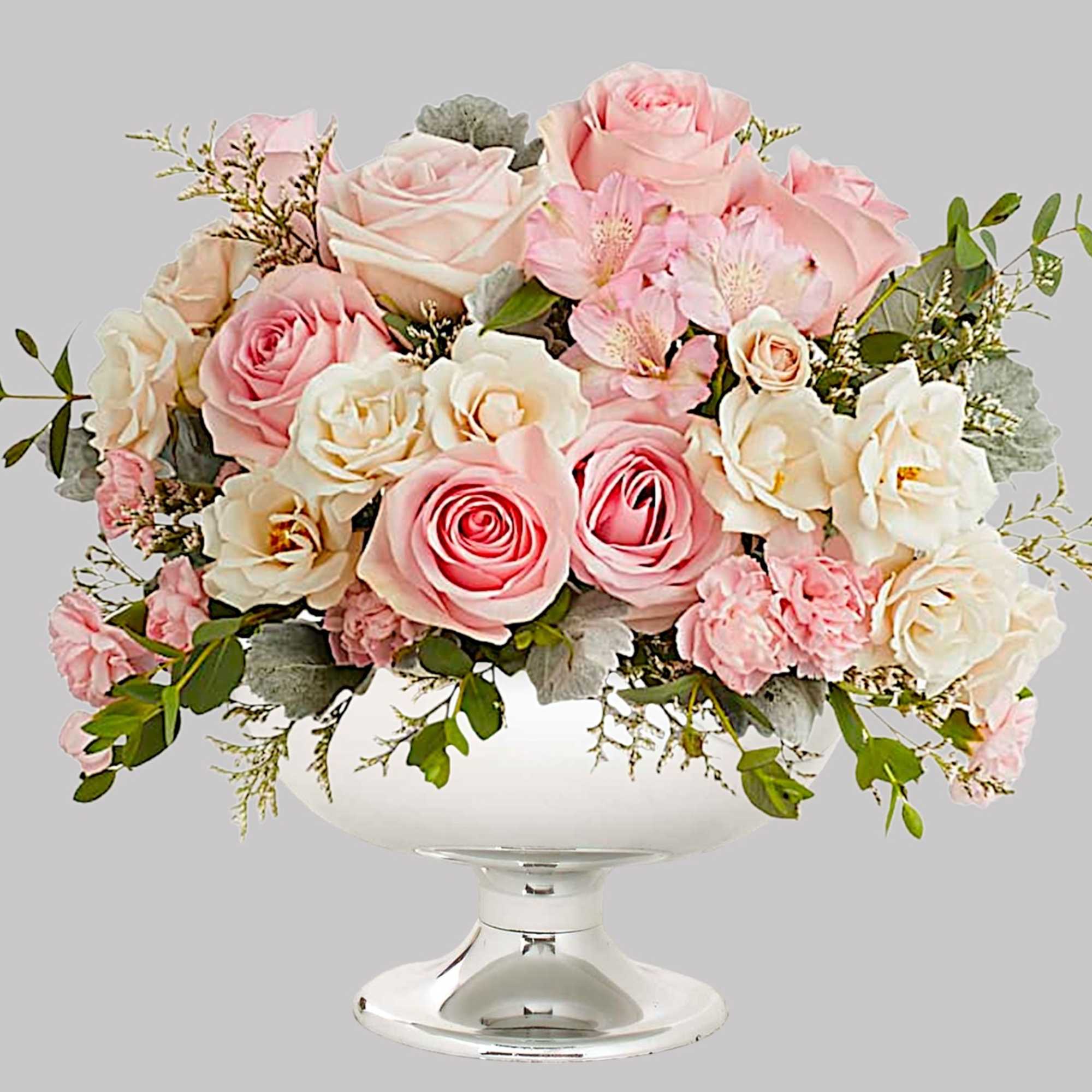 Illuminate love with embracing soft pastel shimmer and cradling an exquisite arrangement