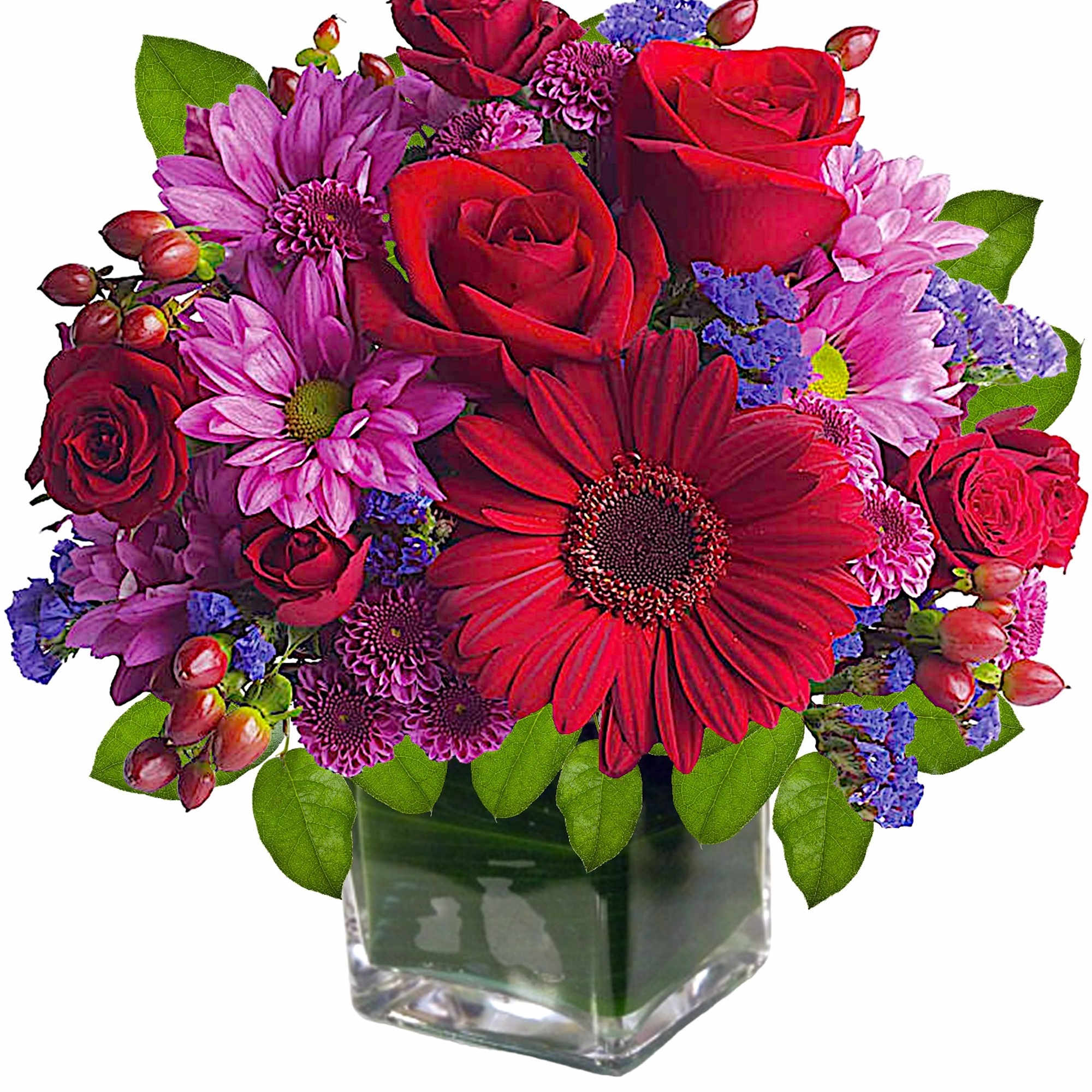 Rich jewel-toned flowers are arranged in a glass cube vase for a