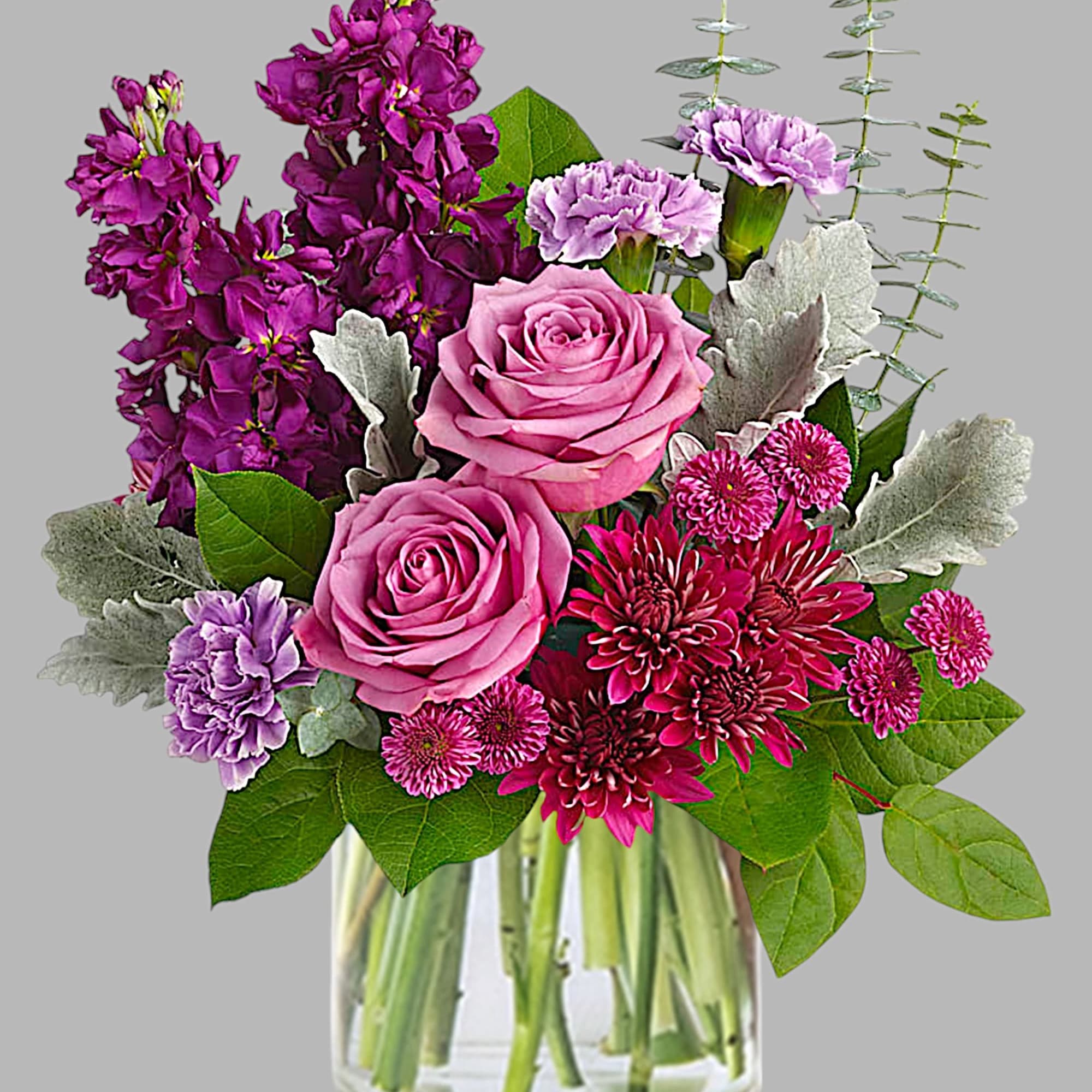 Shimmering with the beauty of a faceted amethyst, this luxurious rose arrangement