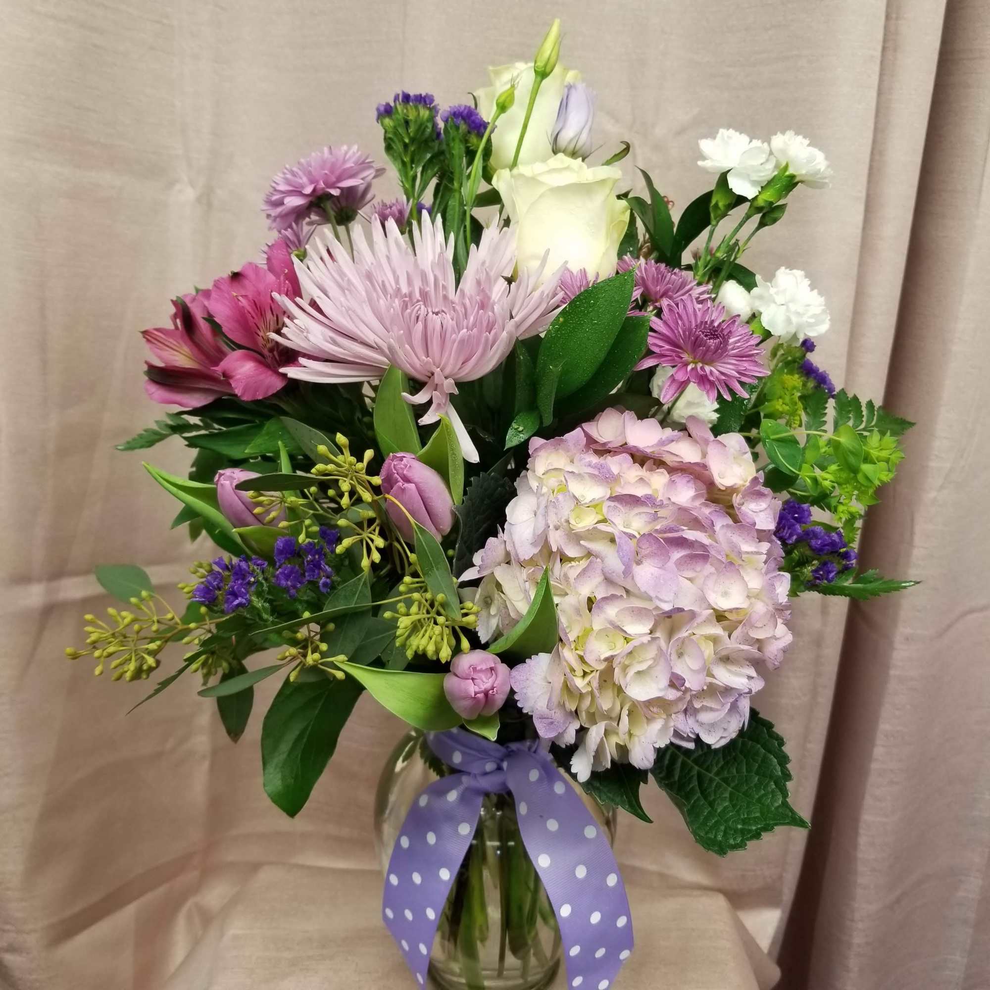 Designed in a vase with tulips, roses, fugies, alstroemeria, mini carnations, hydrangea
