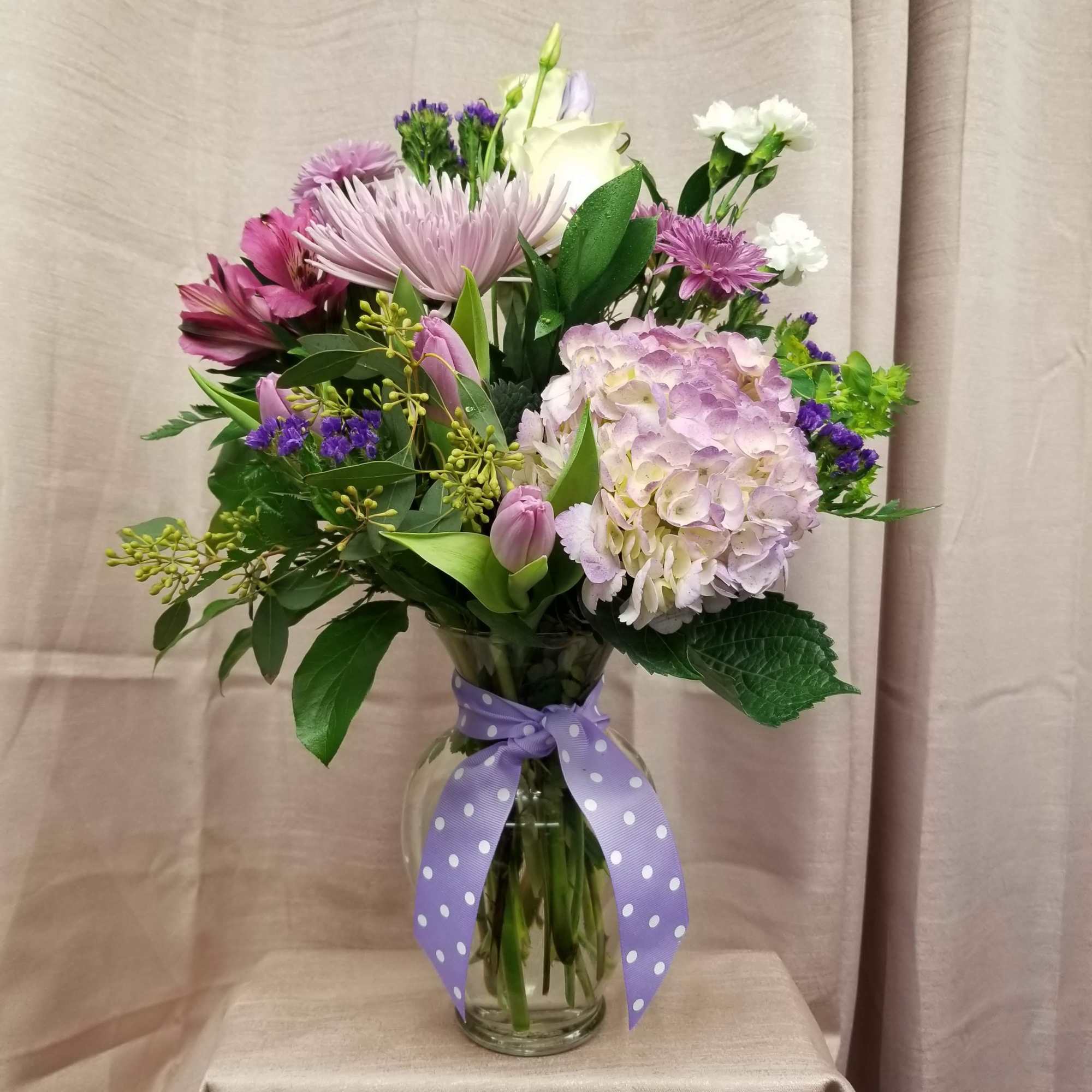 Designed in a vase with tulips, roses, fugies, alstroemeria, mini carnations, hydrangea
