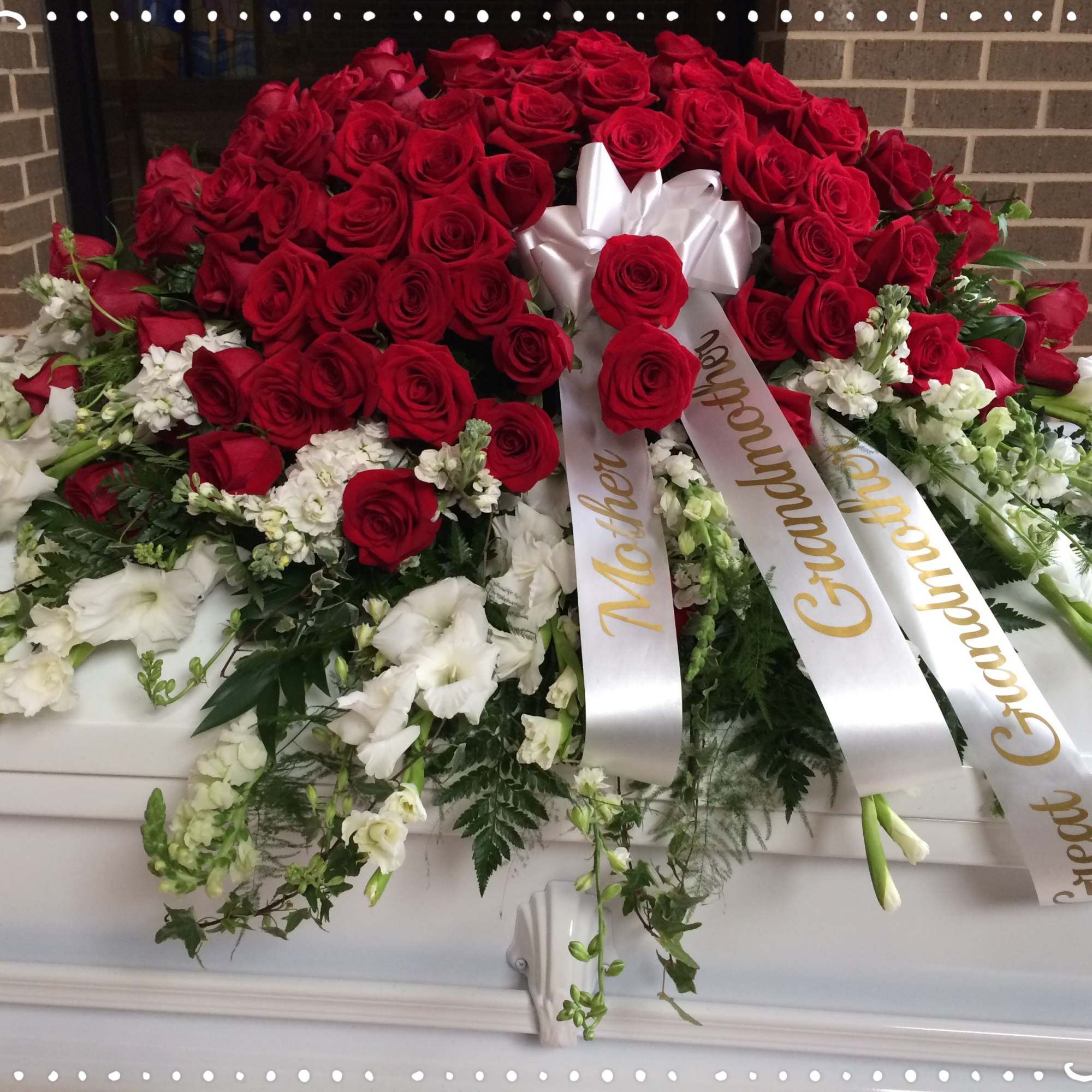 Red roses and/or Carnations over various white flowers