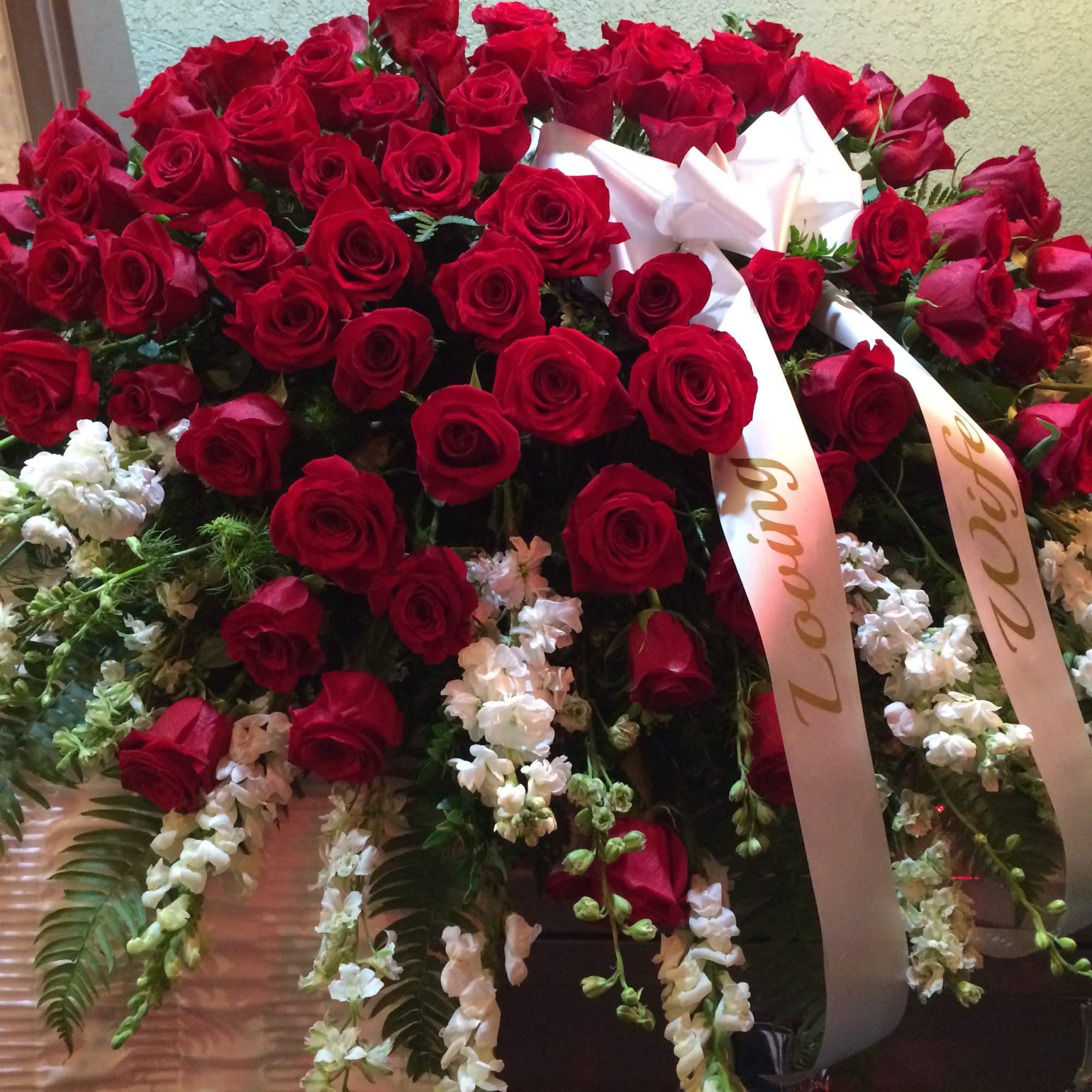 Red roses and/or Carnations over various white flowers