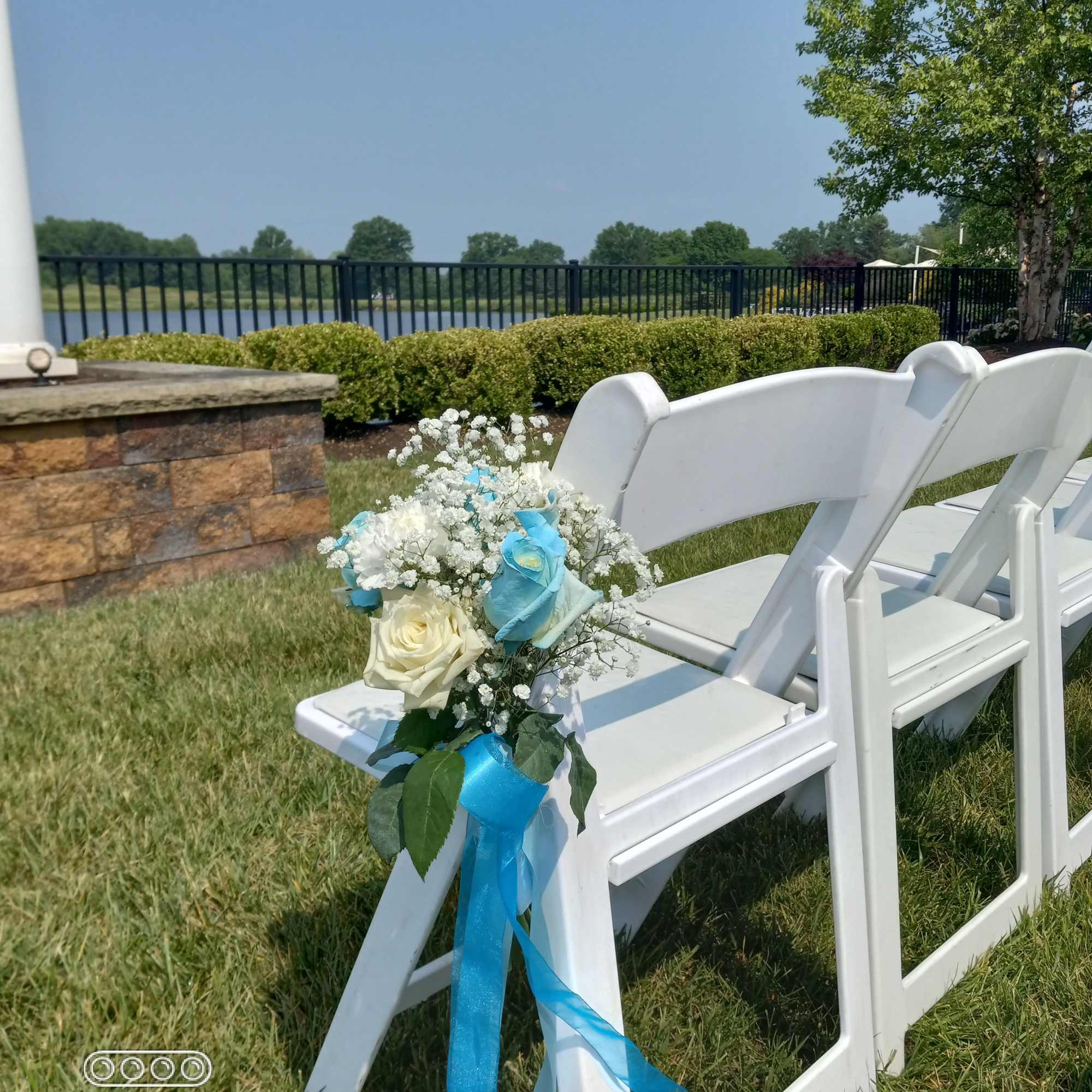 Azul blue and white roses and baby's breath bouquets for the pew