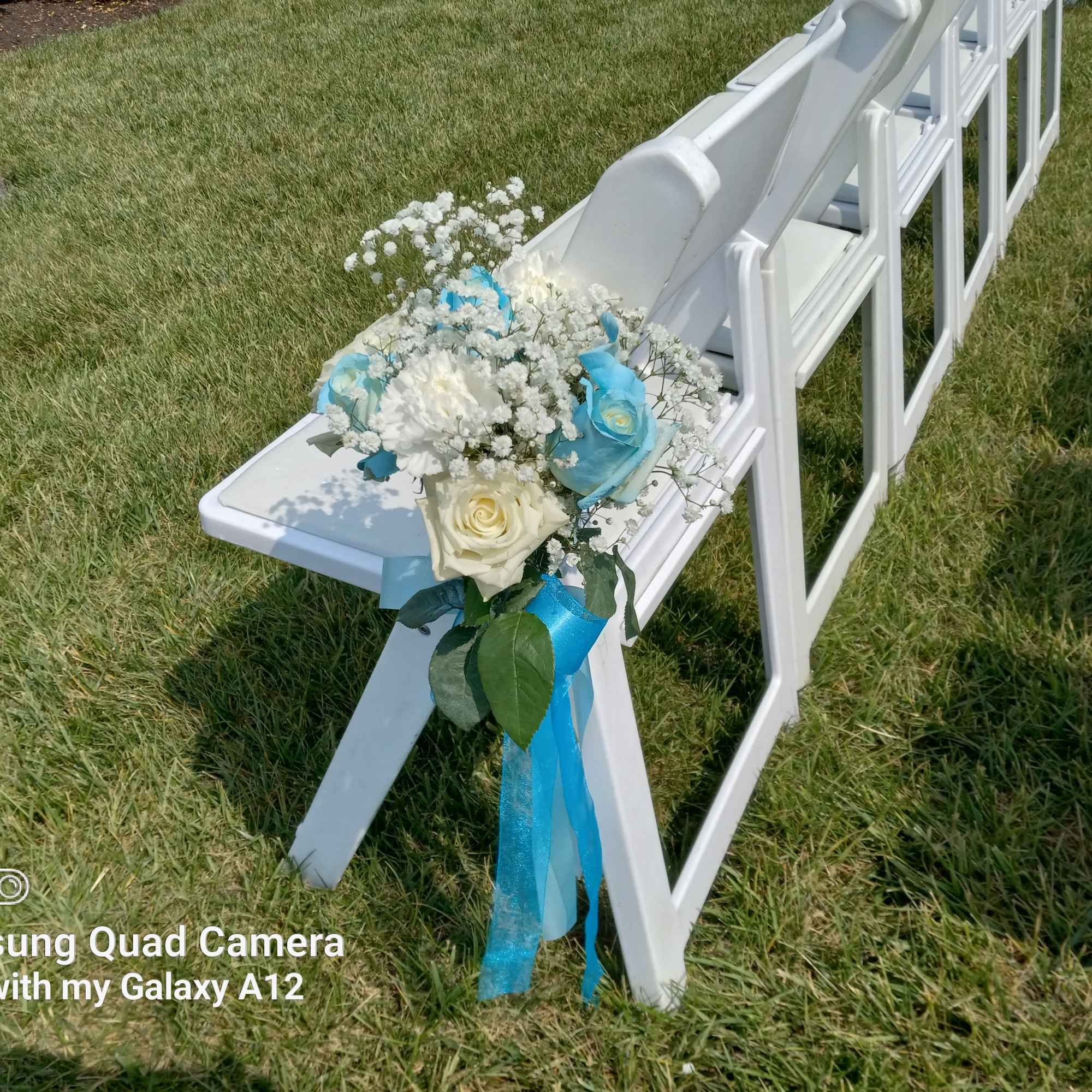 Azul blue and white roses and baby's breath bouquets for the pew