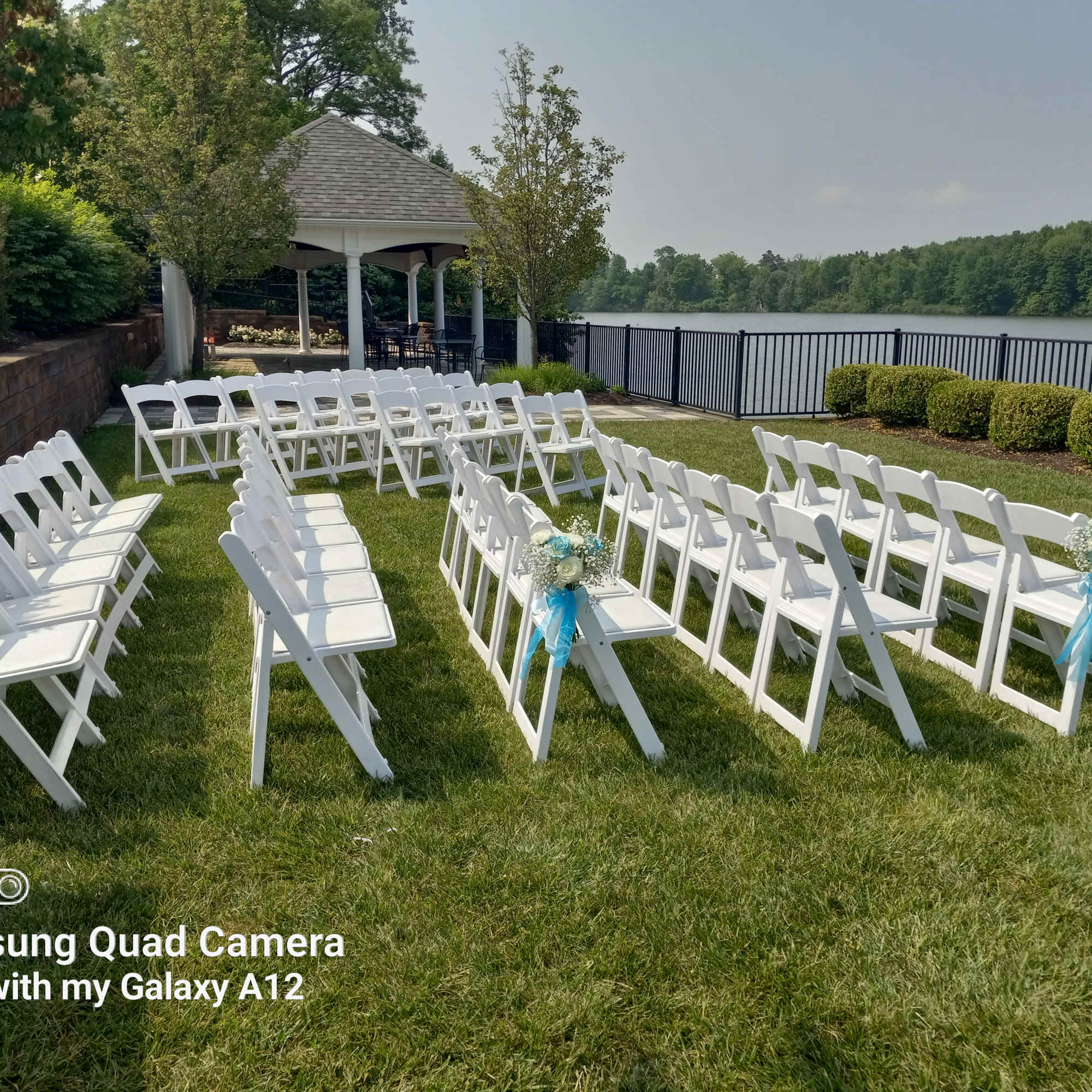 Azul blue and white roses and baby's breath bouquets for the pew