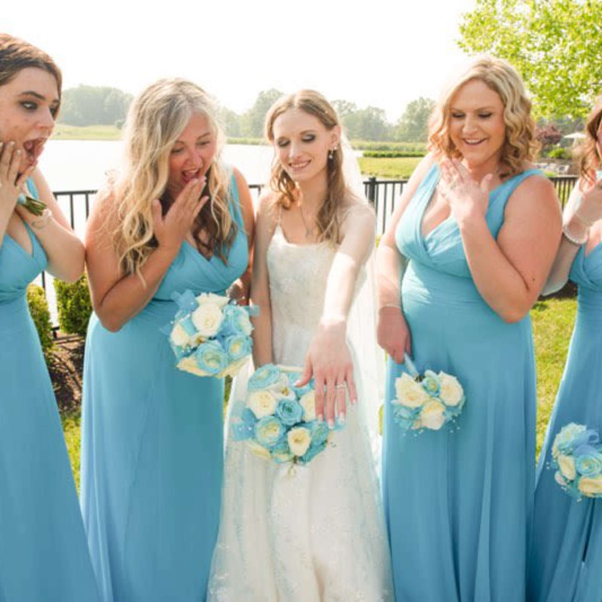 Azul blue and white roses and baby's breath round whimsical bouquets