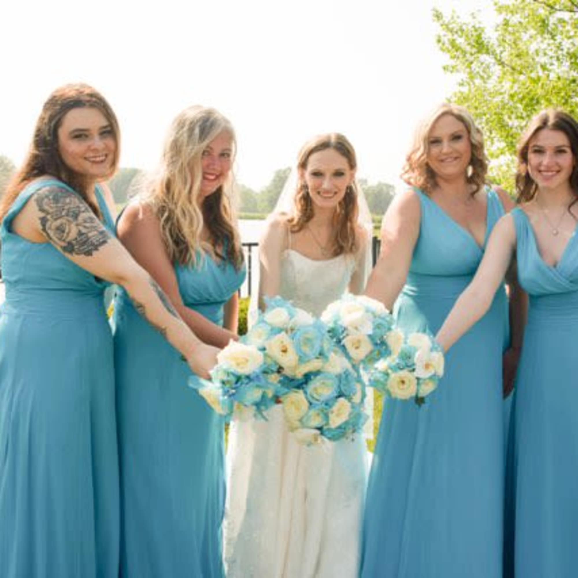 Azul blue and white roses and baby's breath round whimsical bouquets