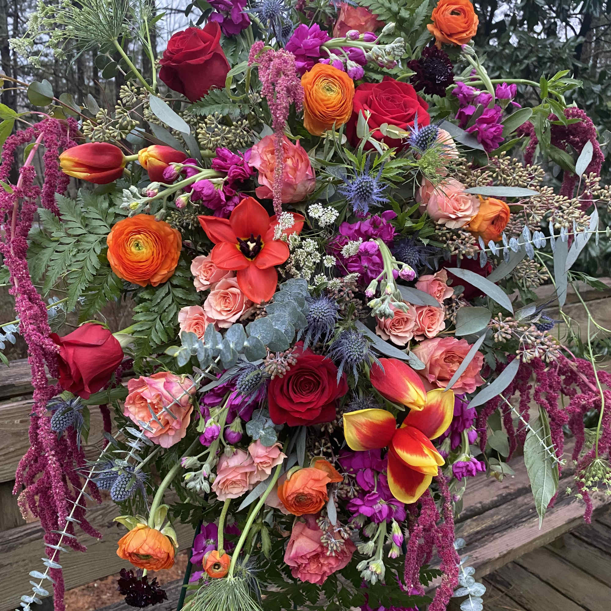 Dramatic funeral spray or wreath with a variety of flowers. Flexible color