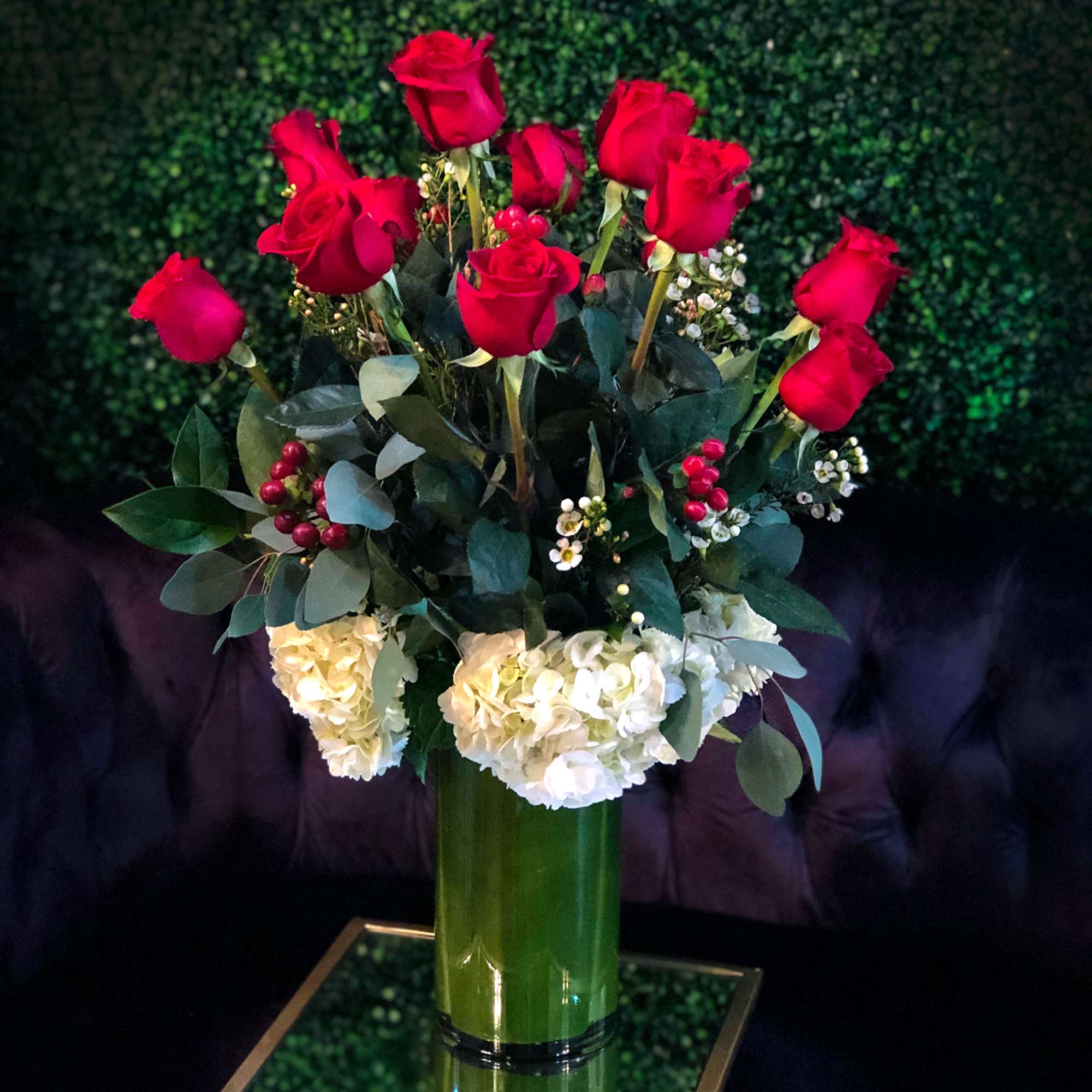 Romanza Italia is made with a dozen roses, hydrangea, seasonal greenery, and