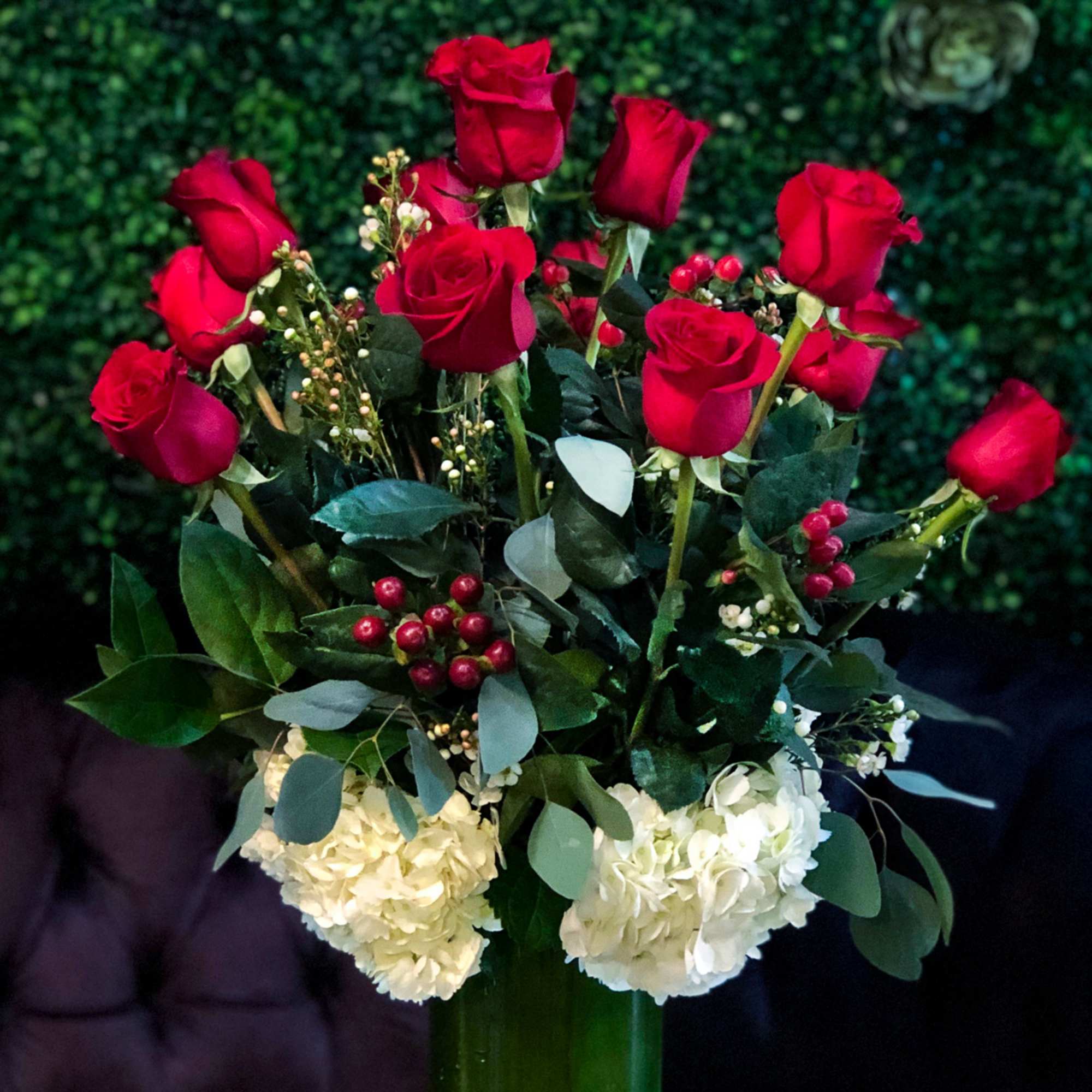 Romanza Italia is made with a dozen roses, hydrangea, seasonal greenery, and