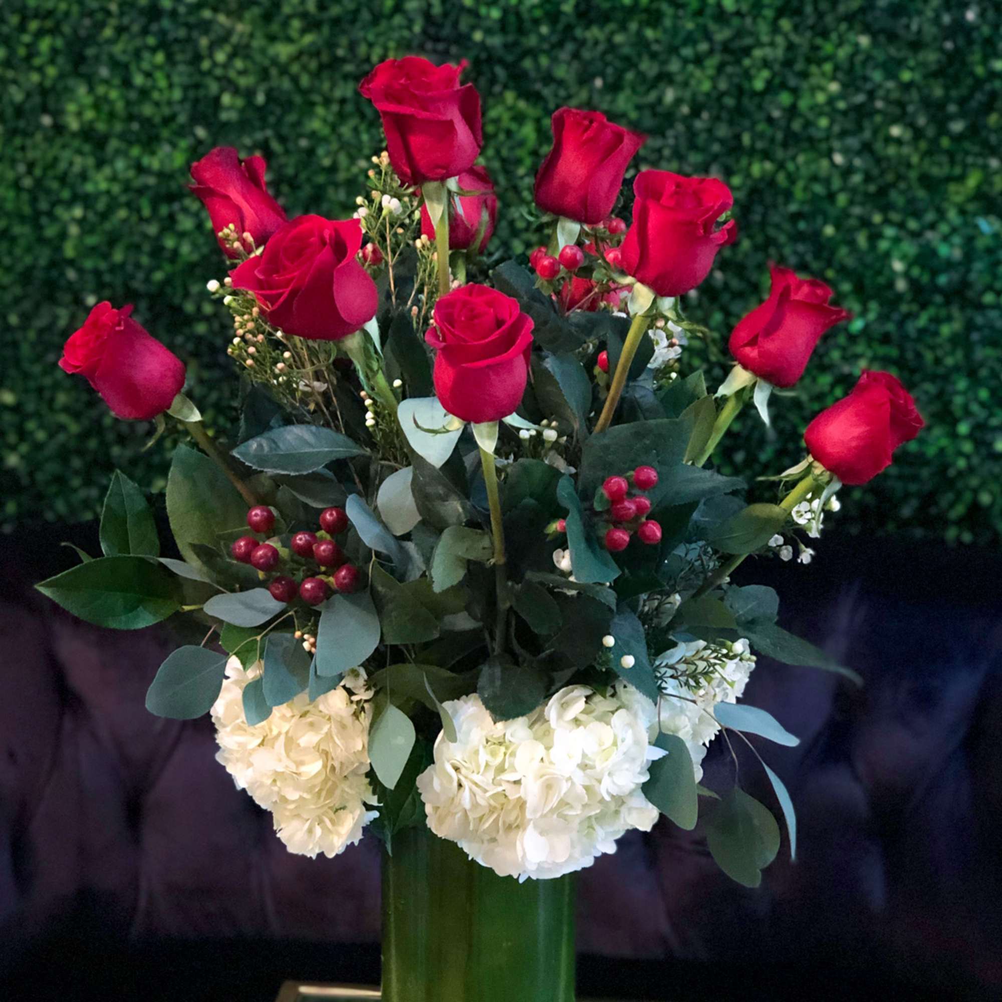 Romanza Italia is made with a dozen roses, hydrangea, seasonal greenery, and