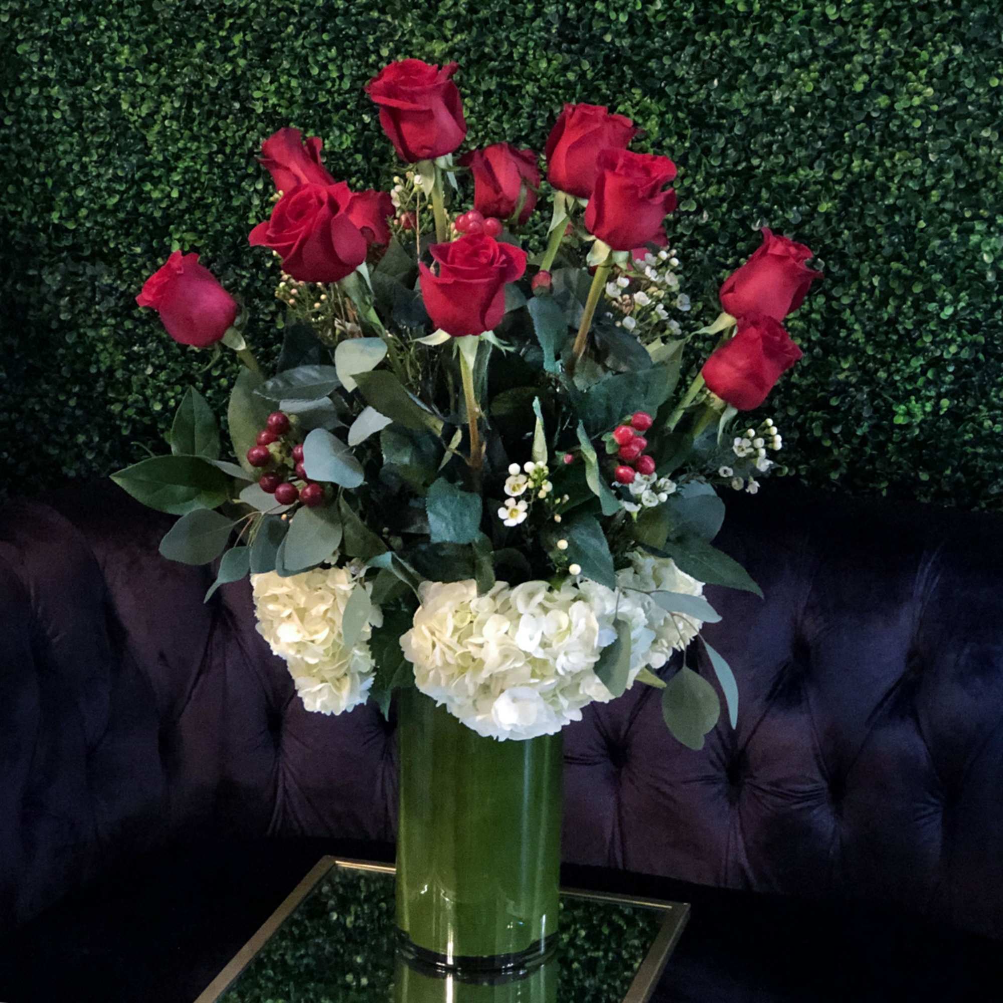 Romanza Italia is made with a dozen roses, hydrangea, seasonal greenery, and