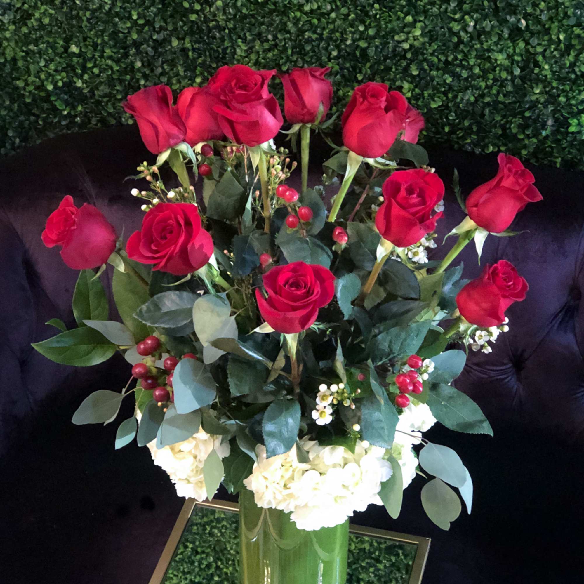 Romanza Italia is made with a dozen roses, hydrangea, seasonal greenery, and