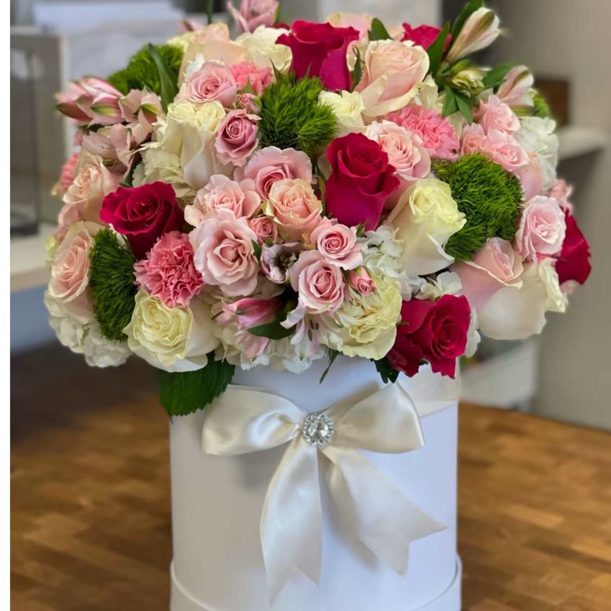 Sunning white hat ox with pink, red roses and hydrangeas and a