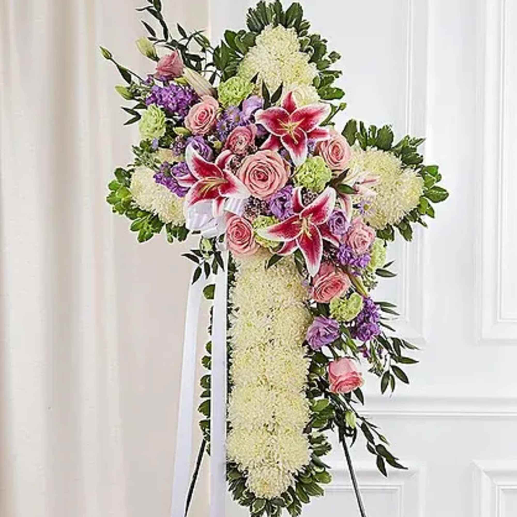 Standing cross arrangement of white football mums and red roses; accented with