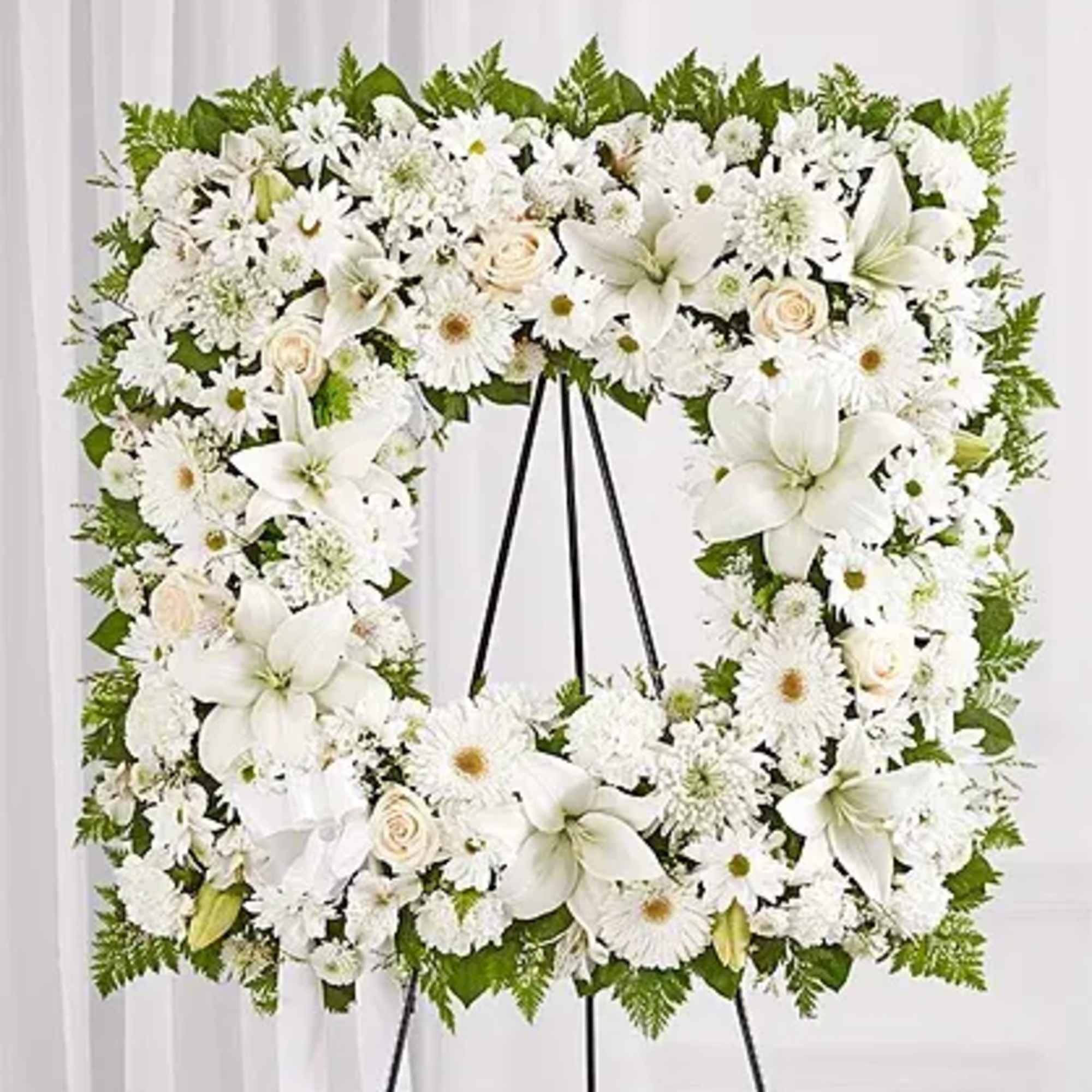 Standing spray arrangement features a stylized 18&quot; square wreath with white roses
