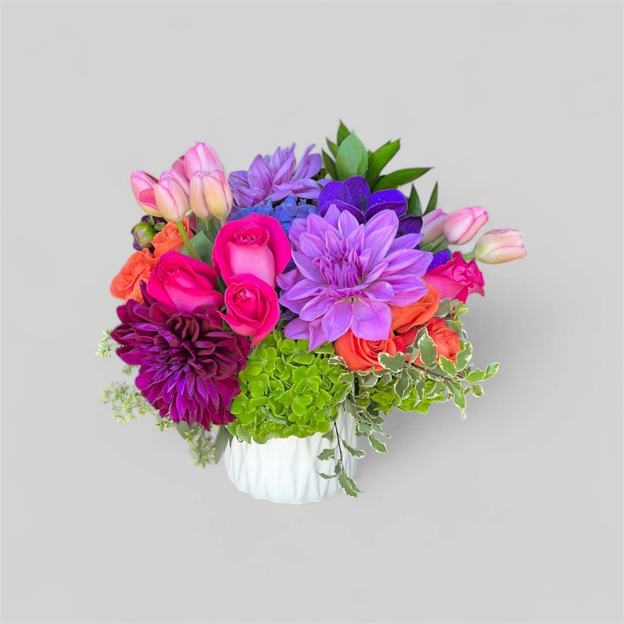 A romantic and feminine arrangement with Esperanza roses surrounded by bright purple