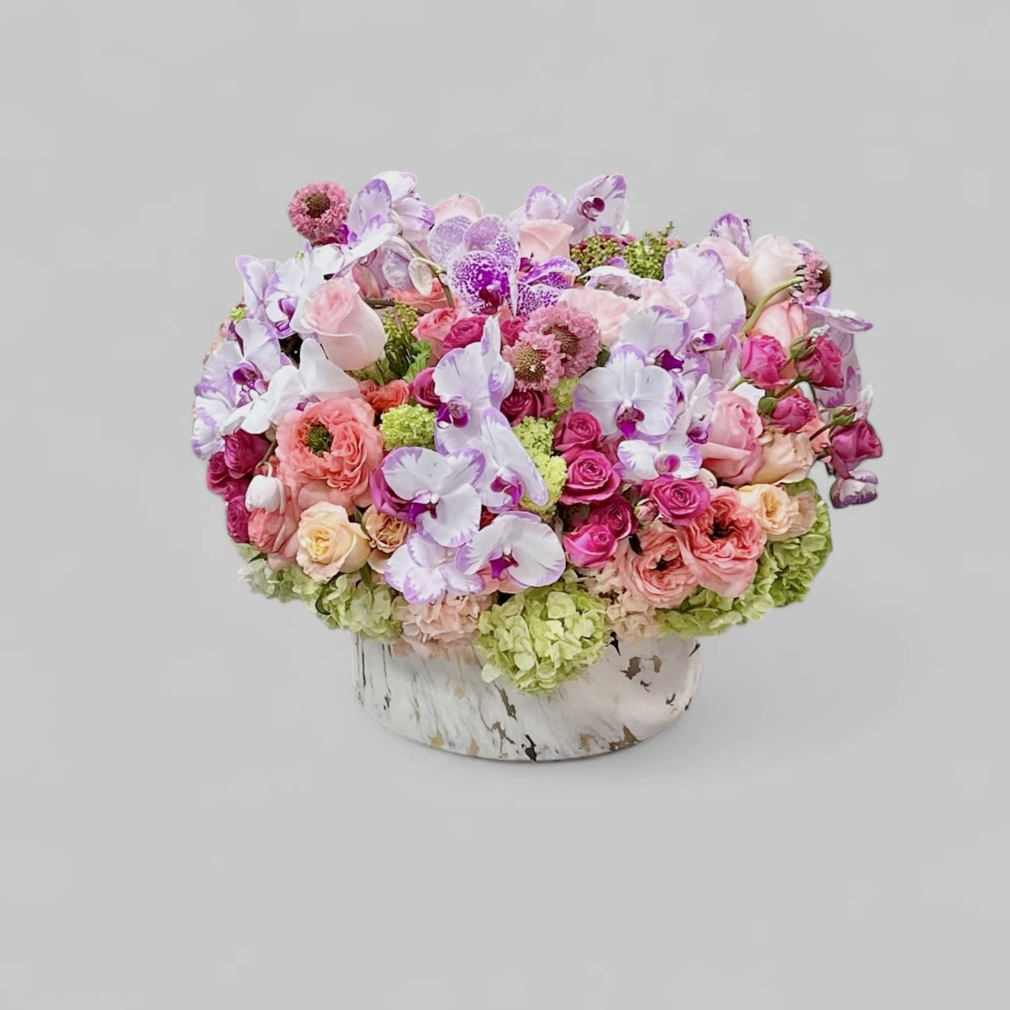 A whimsical combination of white roses and pink roses in a clear