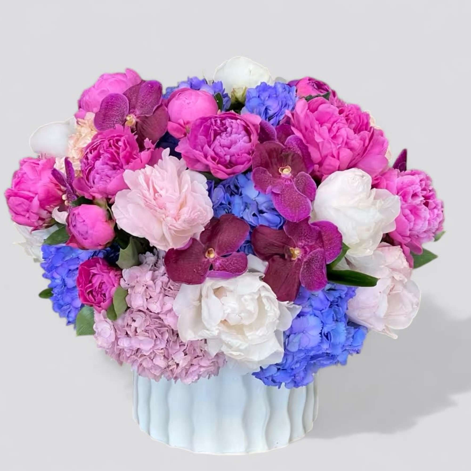 A luscious combination of pinks and purples with elegant orchids, peonies, and