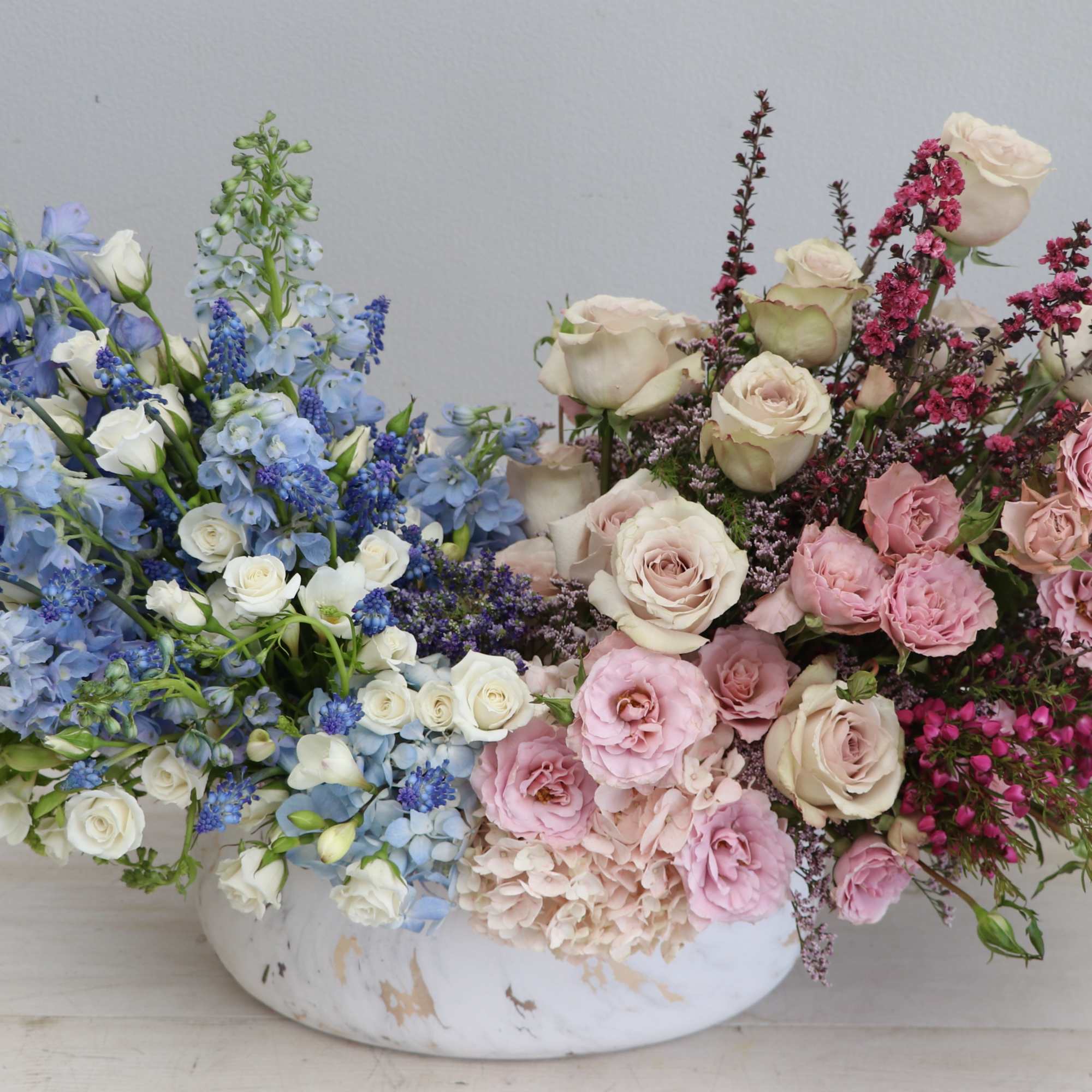 The pink and blue arrangement is composed of a beautiful mix of