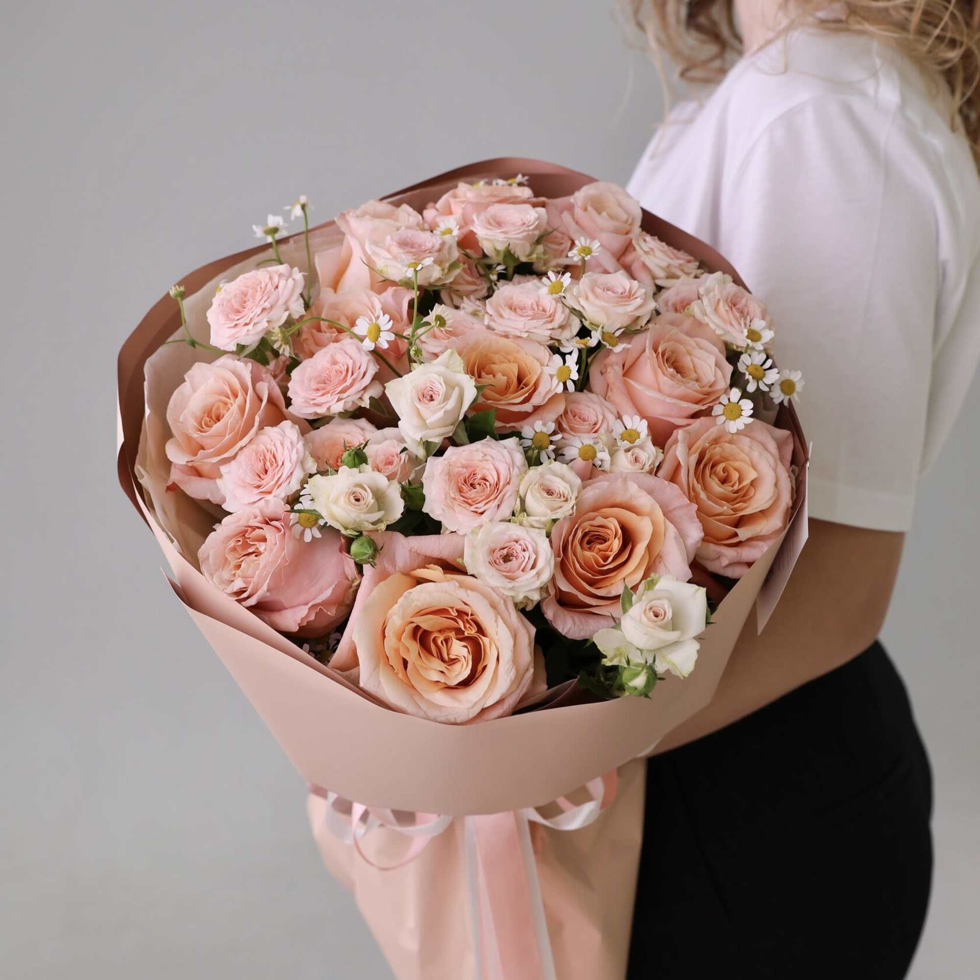 Bouquet of mixed roses and spray roses.