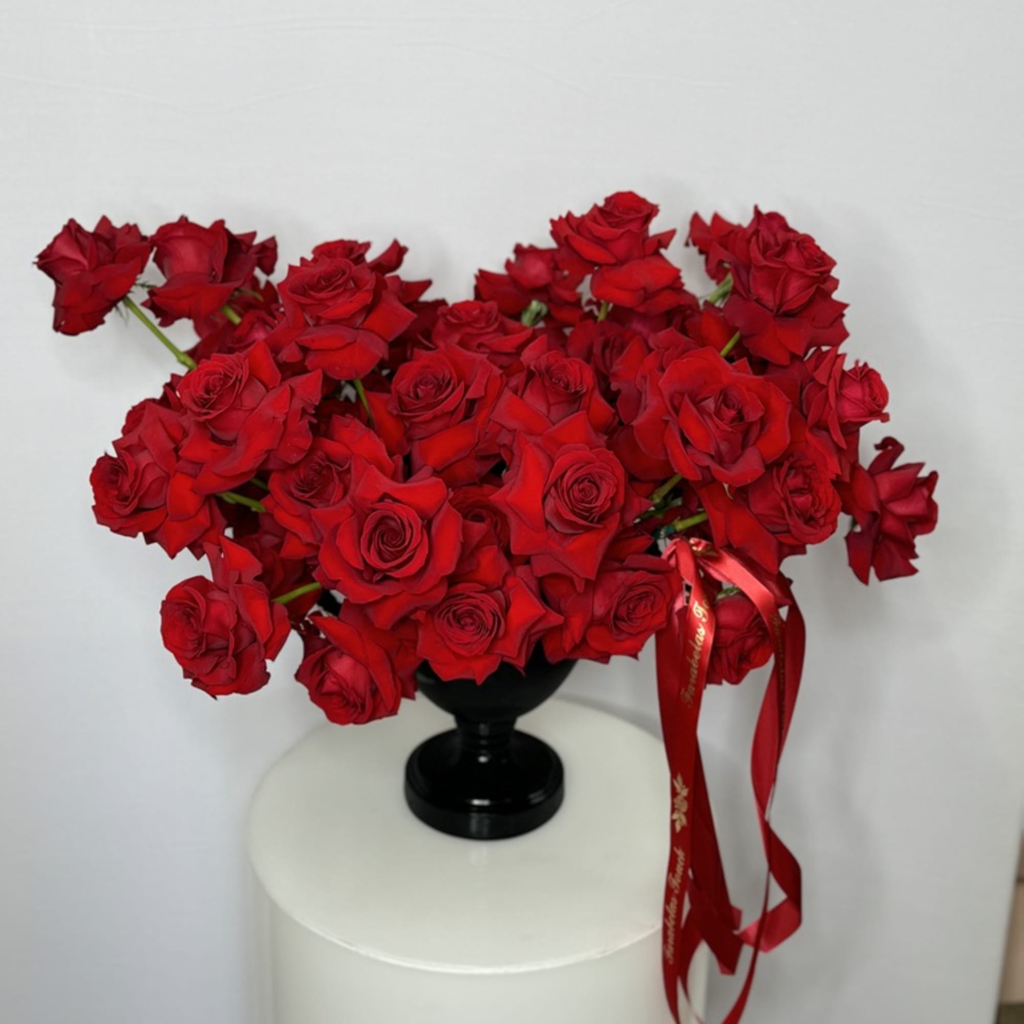 The modern style arrangement in the black vase is an exquisite display