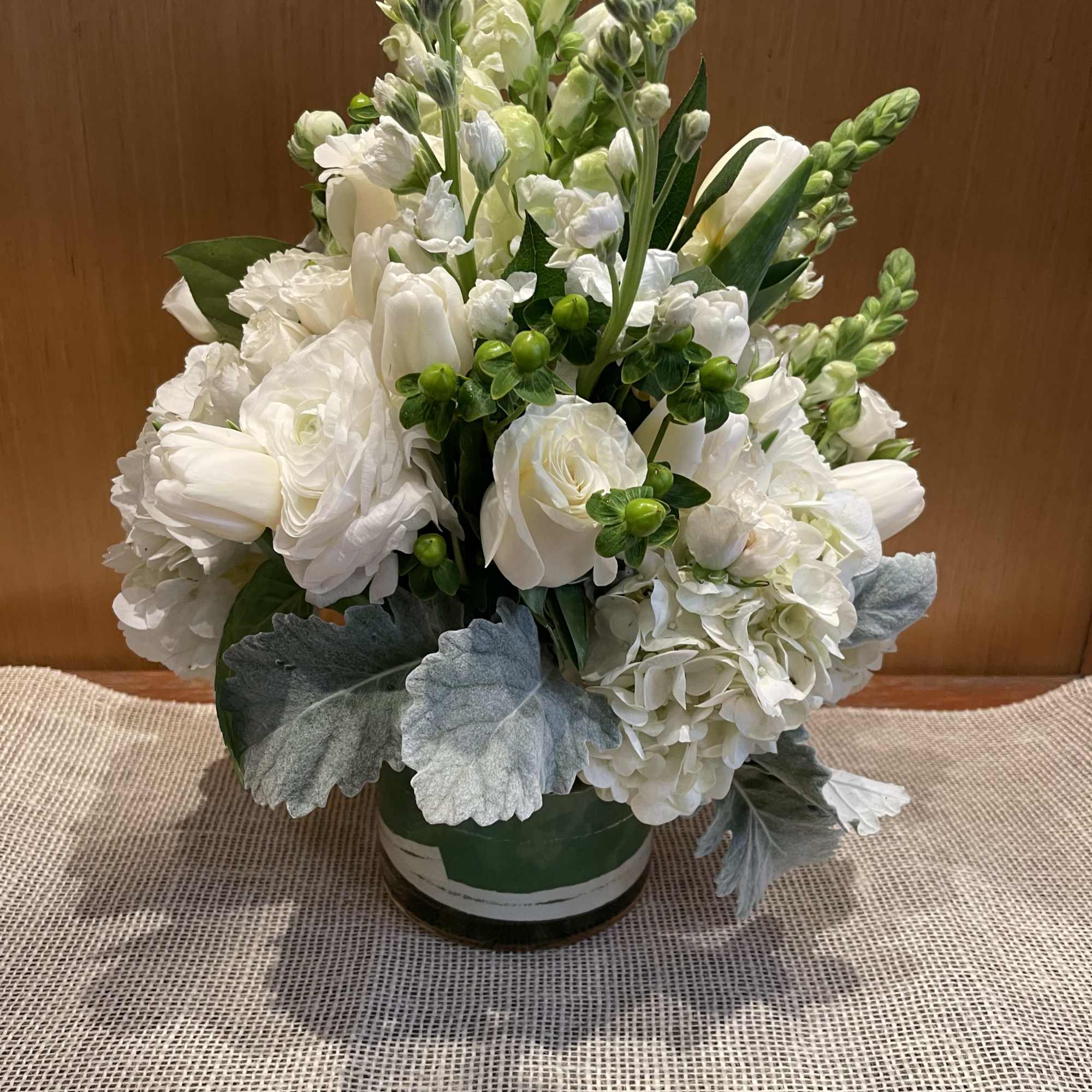This classic arrangement featuring roses, hypericum, snapdragon, hydrangeas, white tulips, and specialty