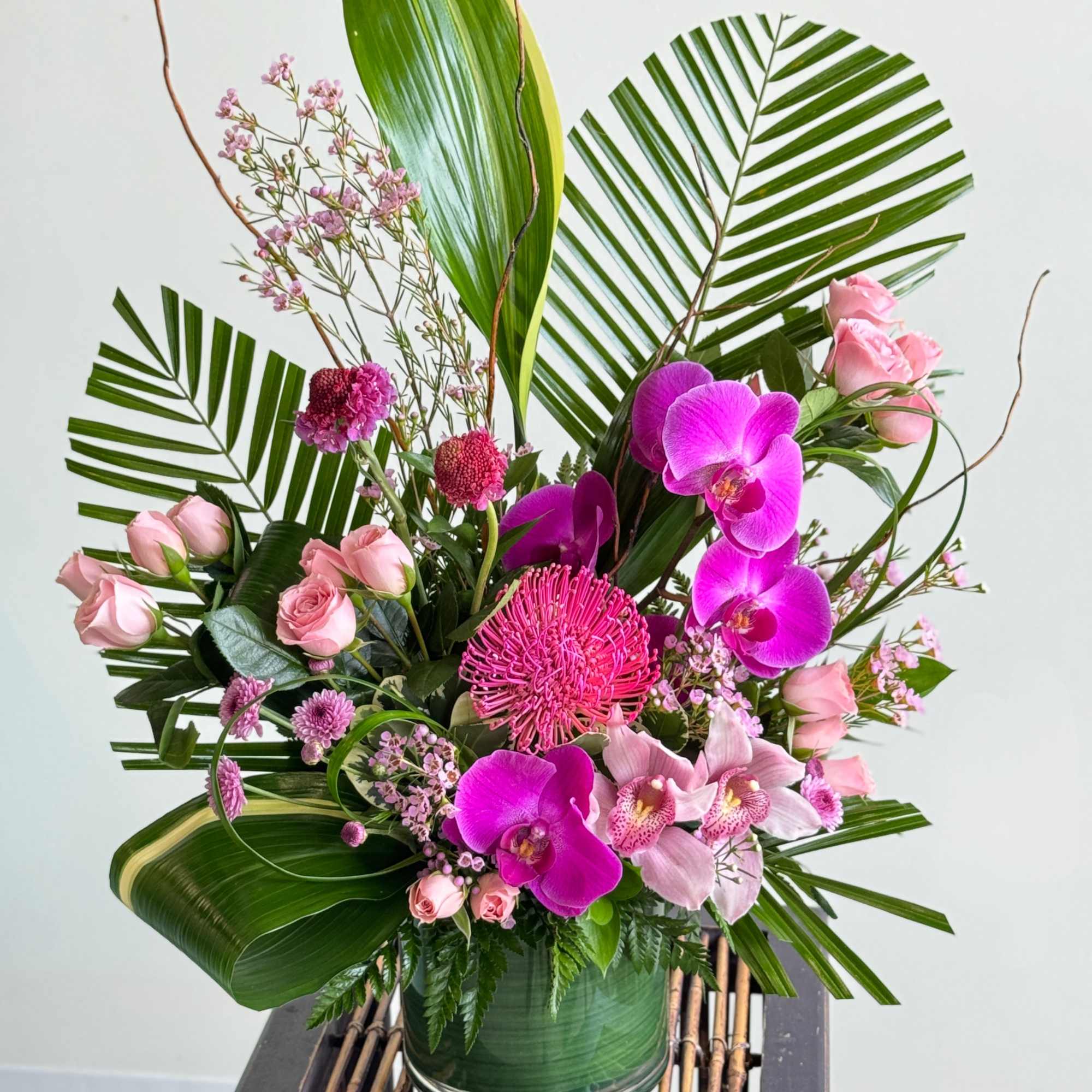 A gorgeous arrangement of tropical stems. Colors are customizable. Please call in A gorgeous arrangement of tropical stems. Colors are customizable. Please call in