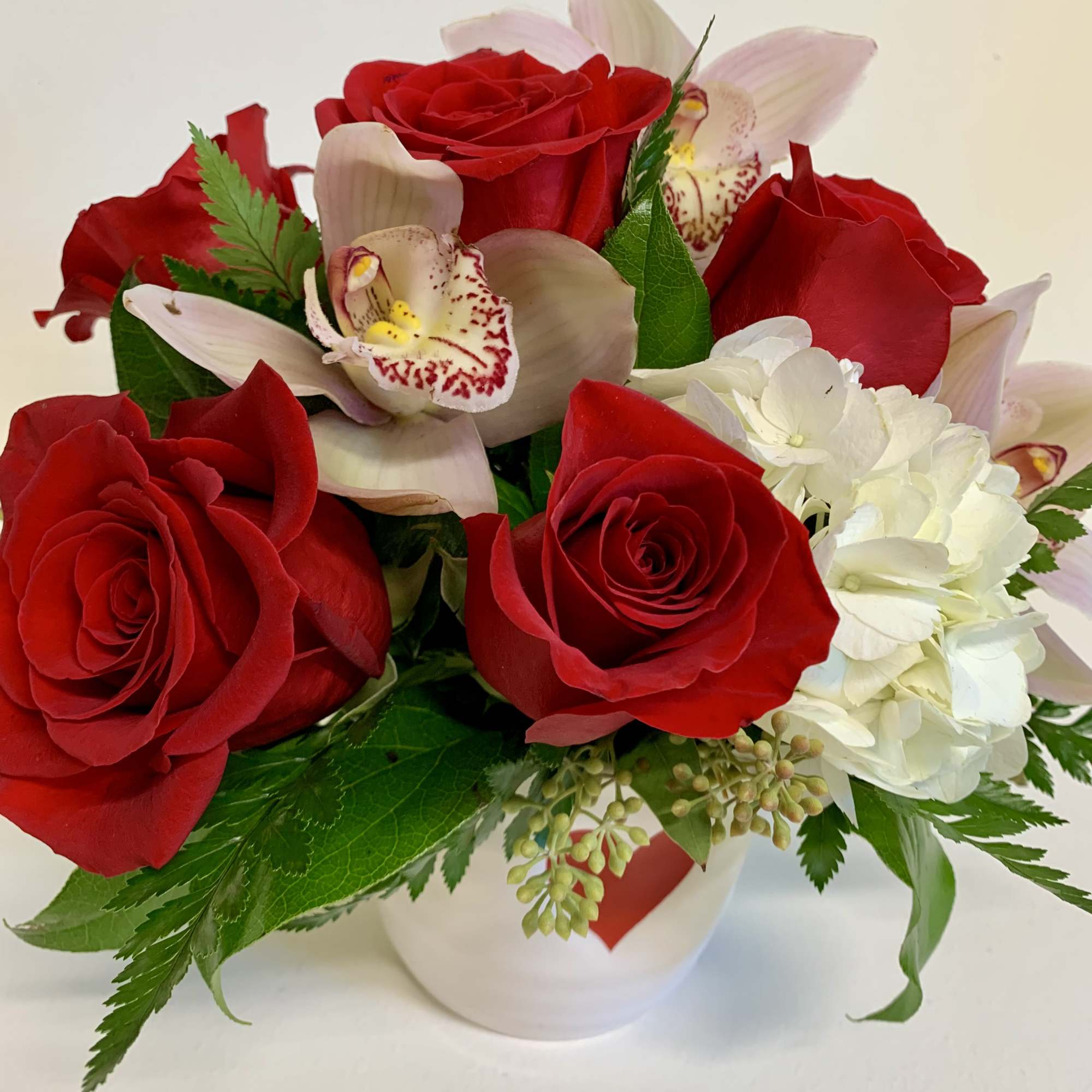A short and stout vase of pure love.  Red roses, pink