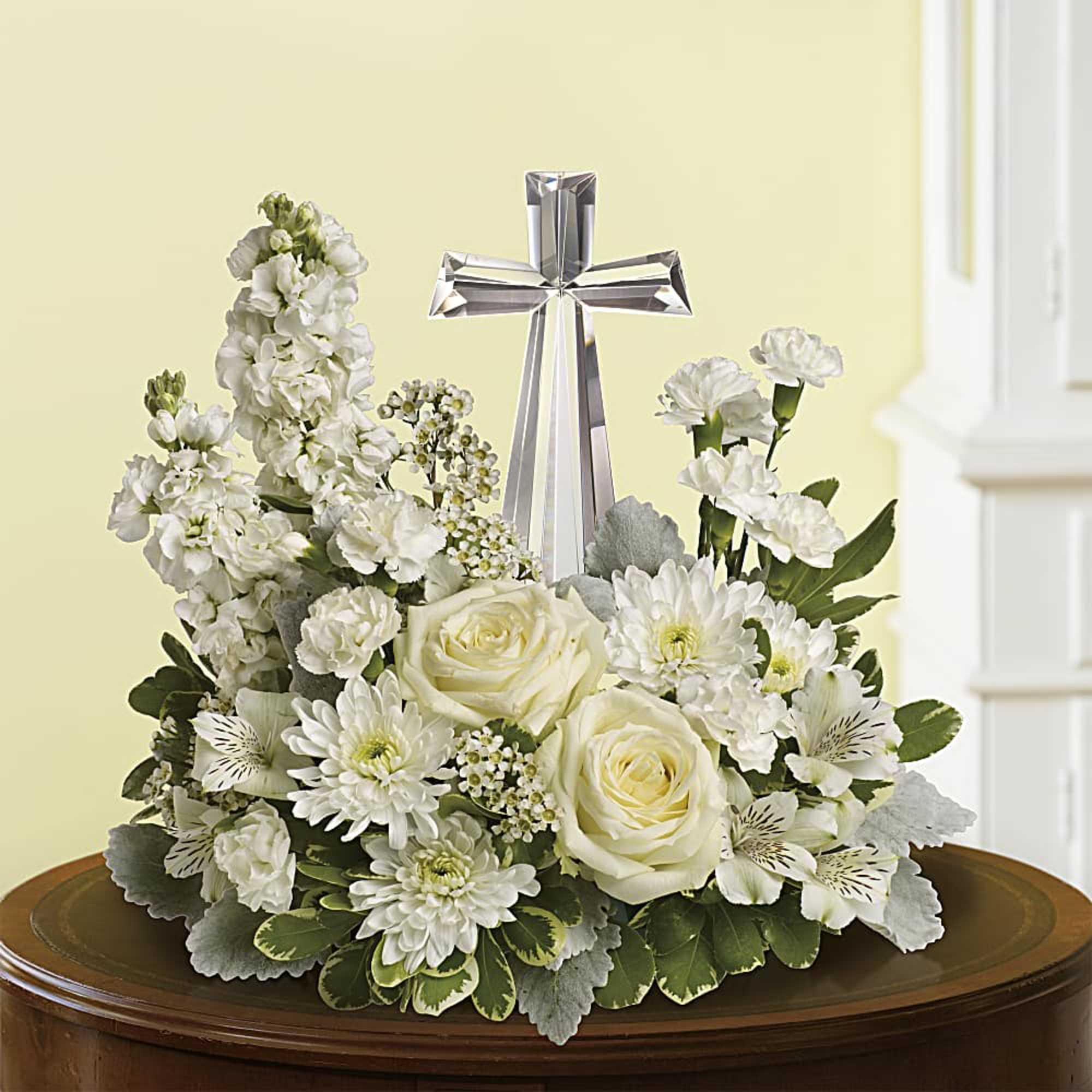 An elegant display of faith and divine peace, this beautiful arrangement will