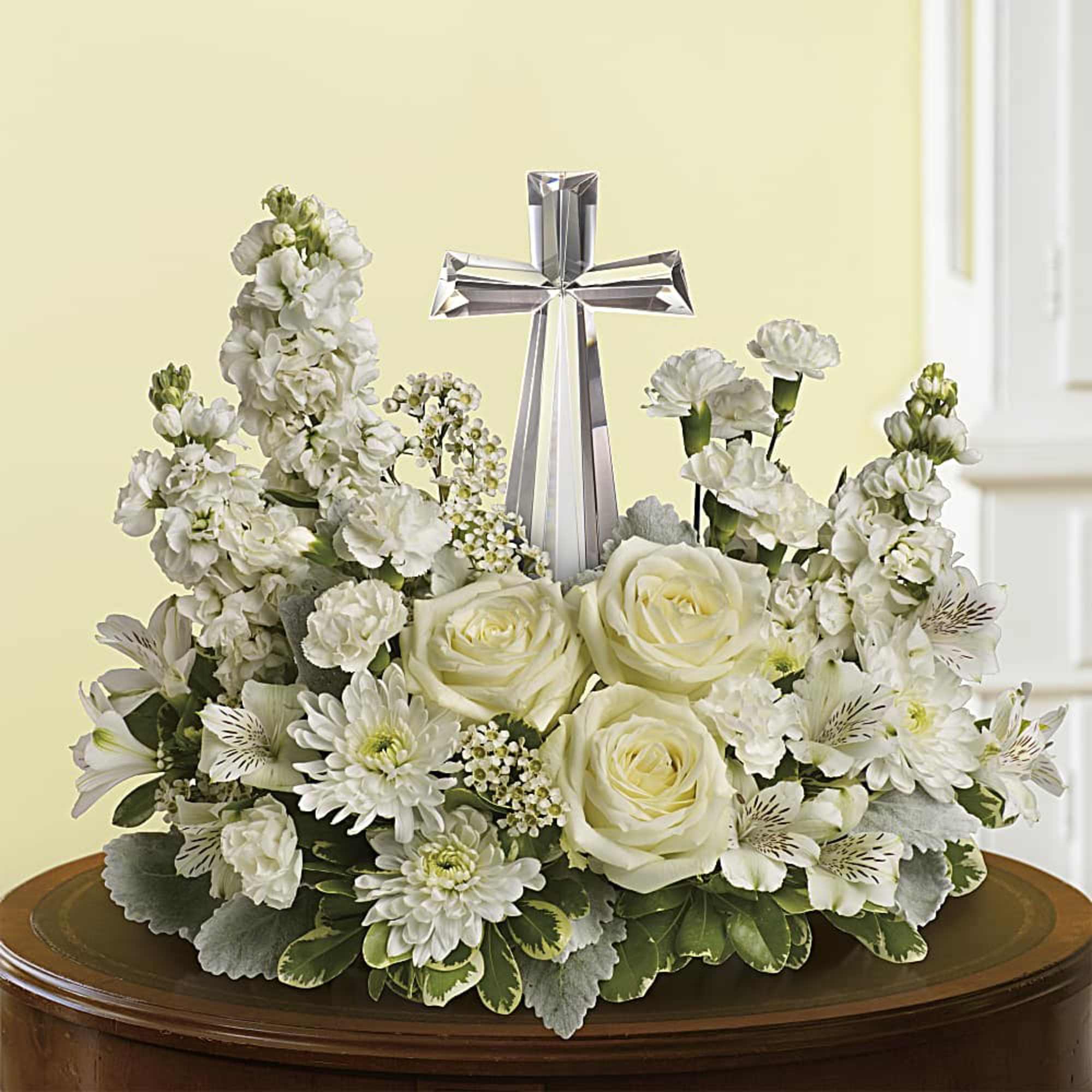 An elegant display of faith and divine peace, this beautiful arrangement will