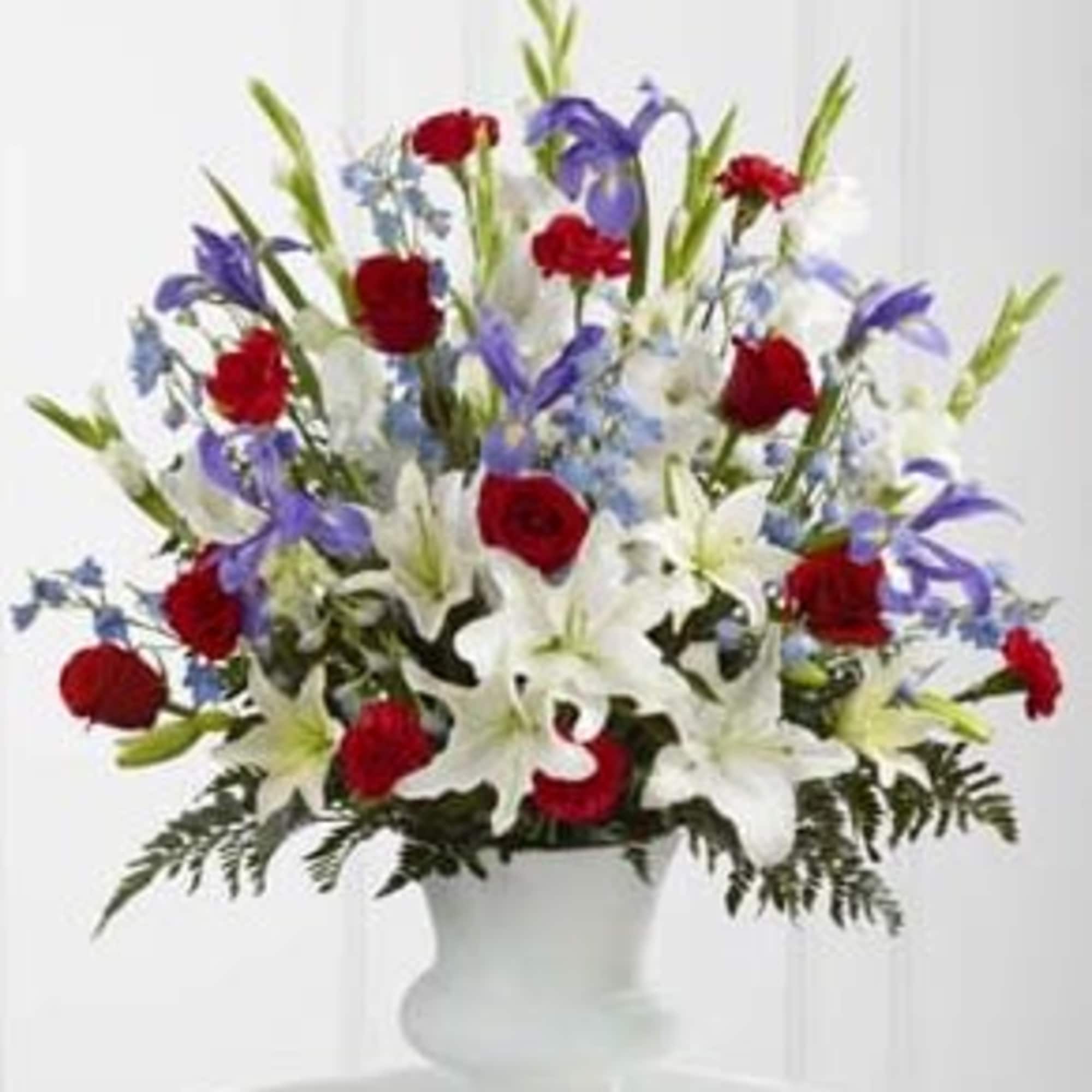 The Cherished Farewell Arrangement is an elegant display of patriotic beauty to