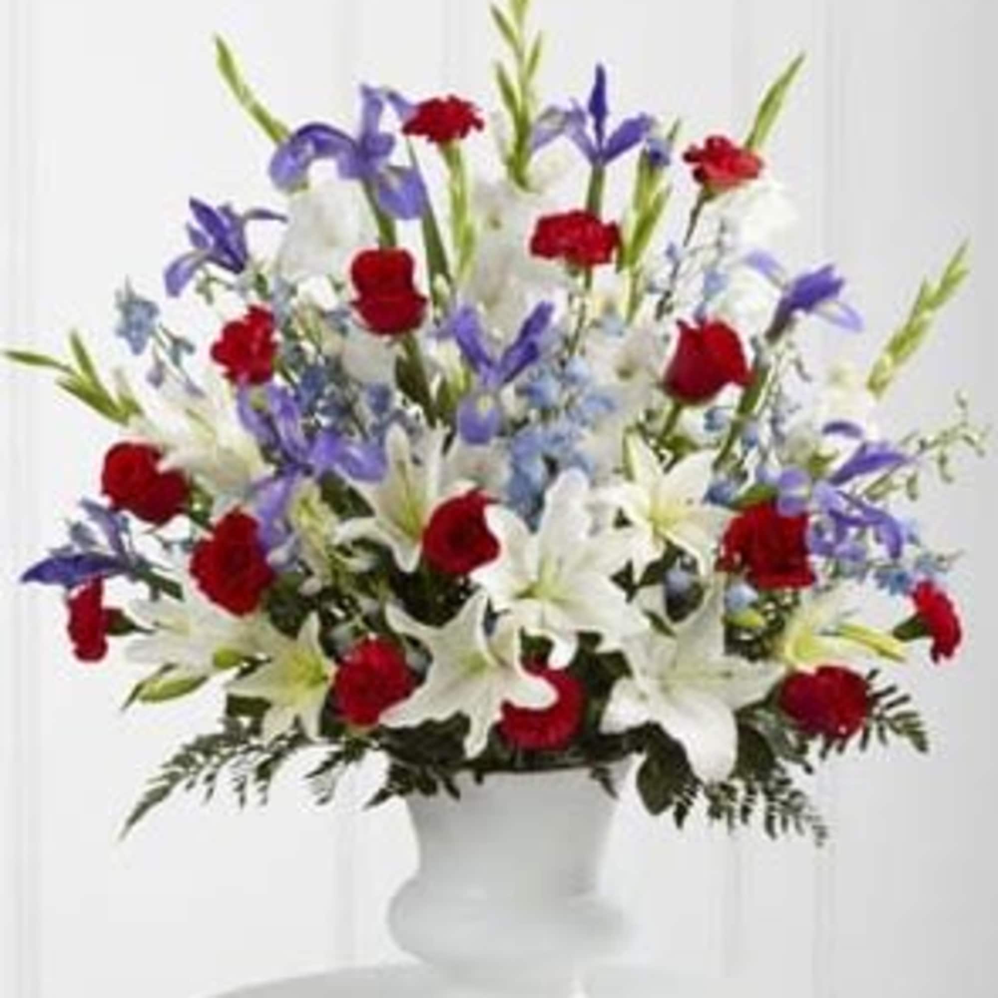 The Cherished Farewell Arrangement is an elegant display of patriotic beauty to